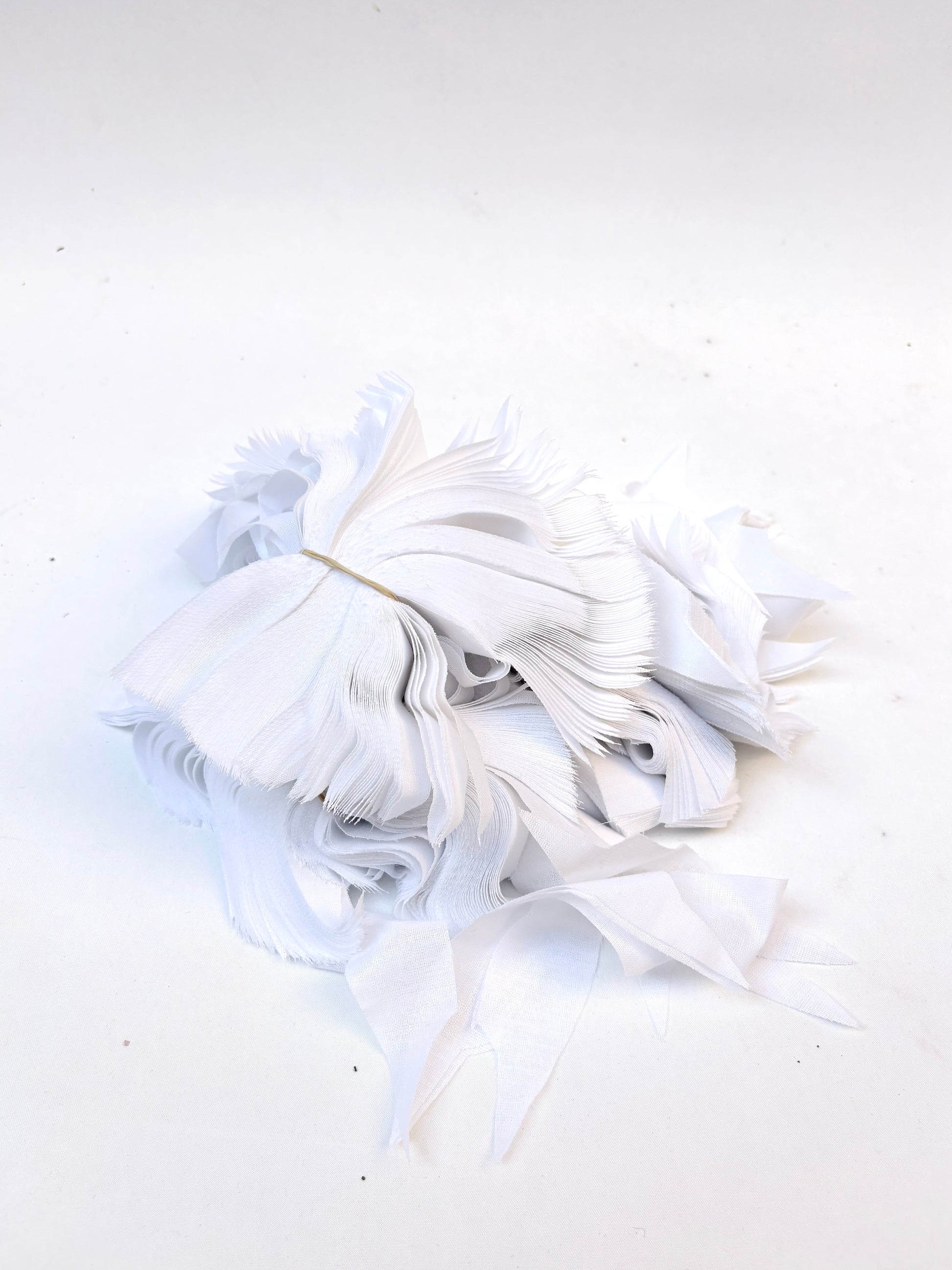 Bundles of fusible woven interfacing offcuts fabric in white 