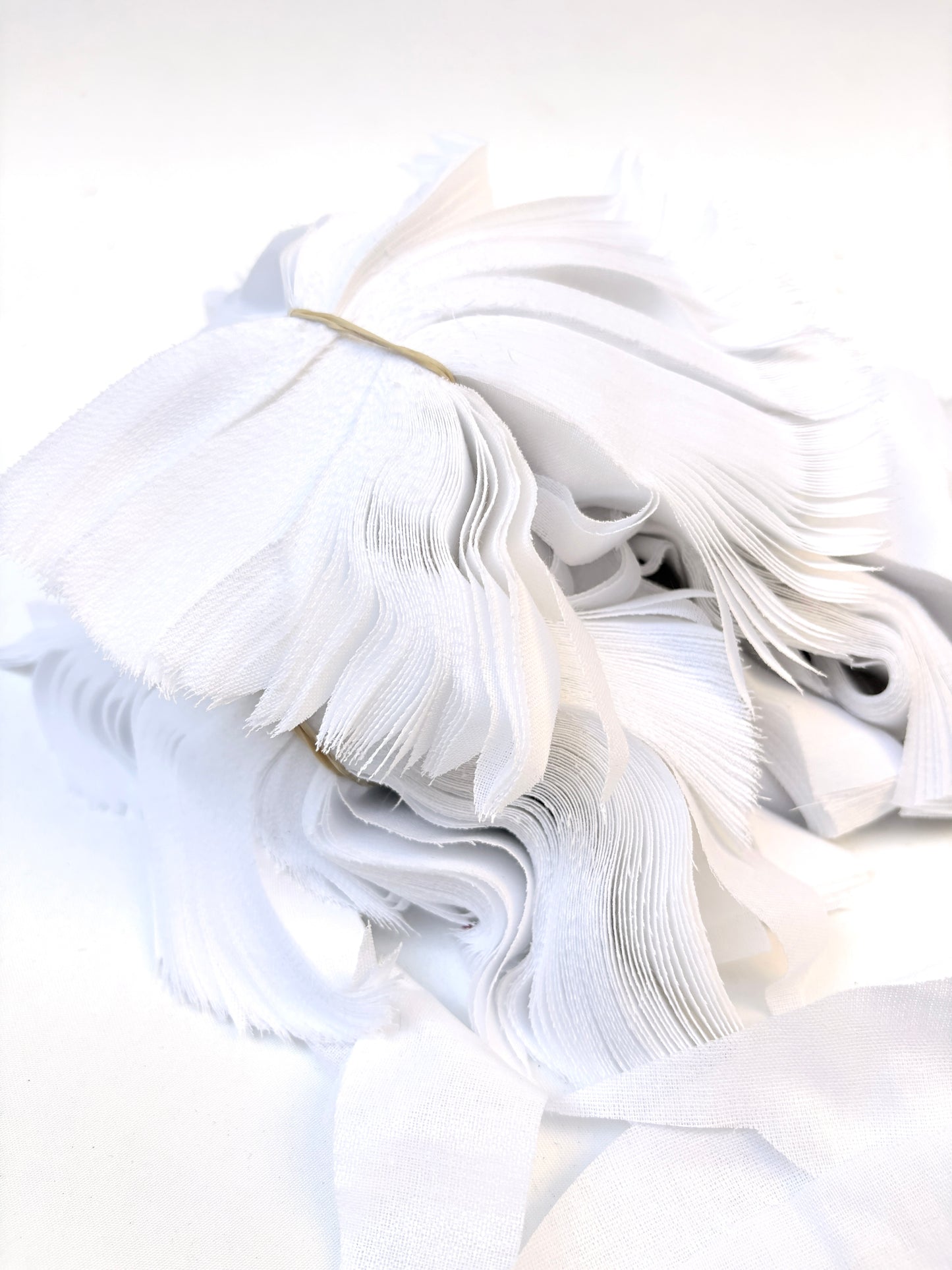Bundles of fusible woven interfacing offcuts fabric in white 