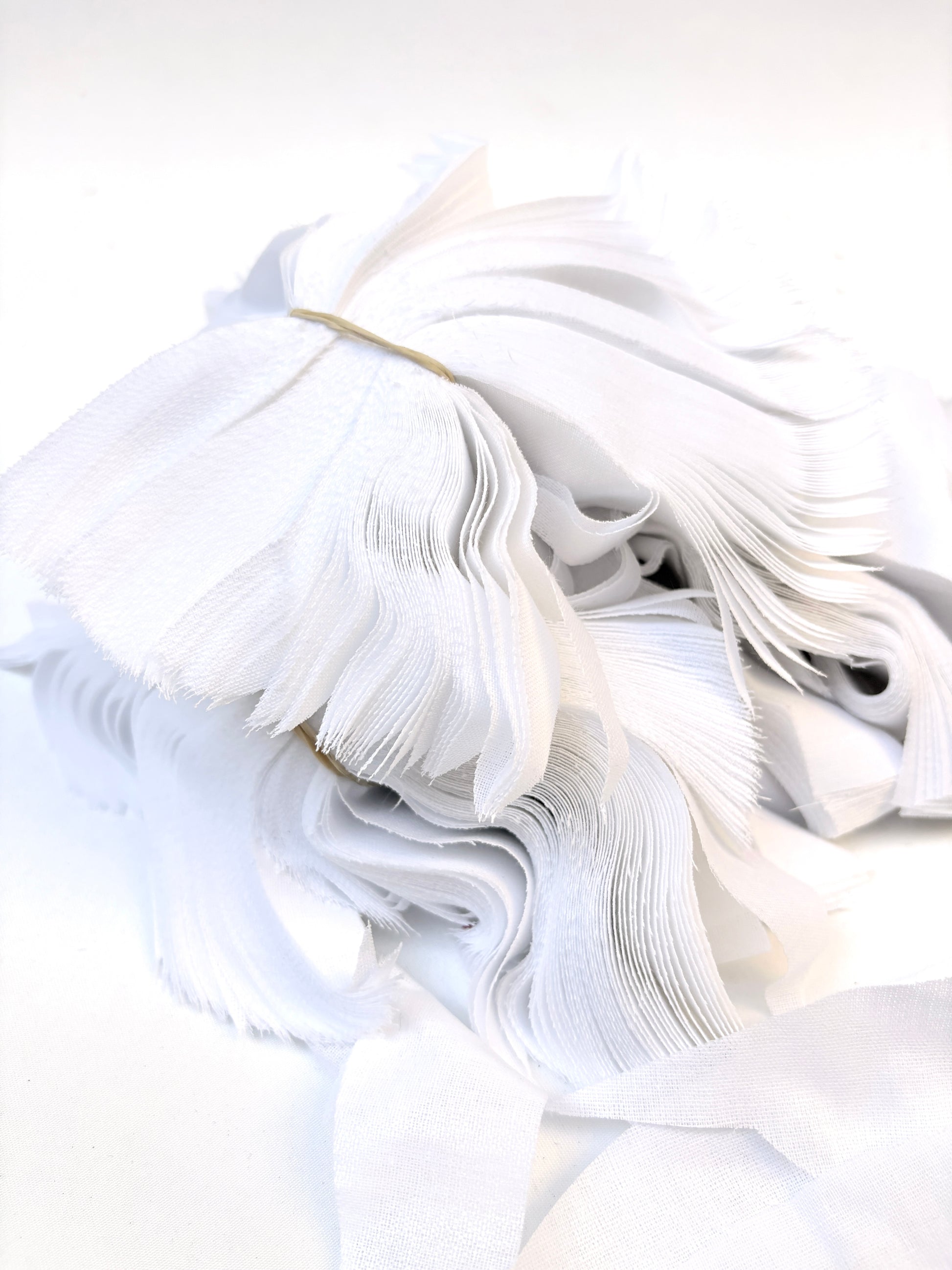 Bundles of fusible woven interfacing offcuts fabric in white 