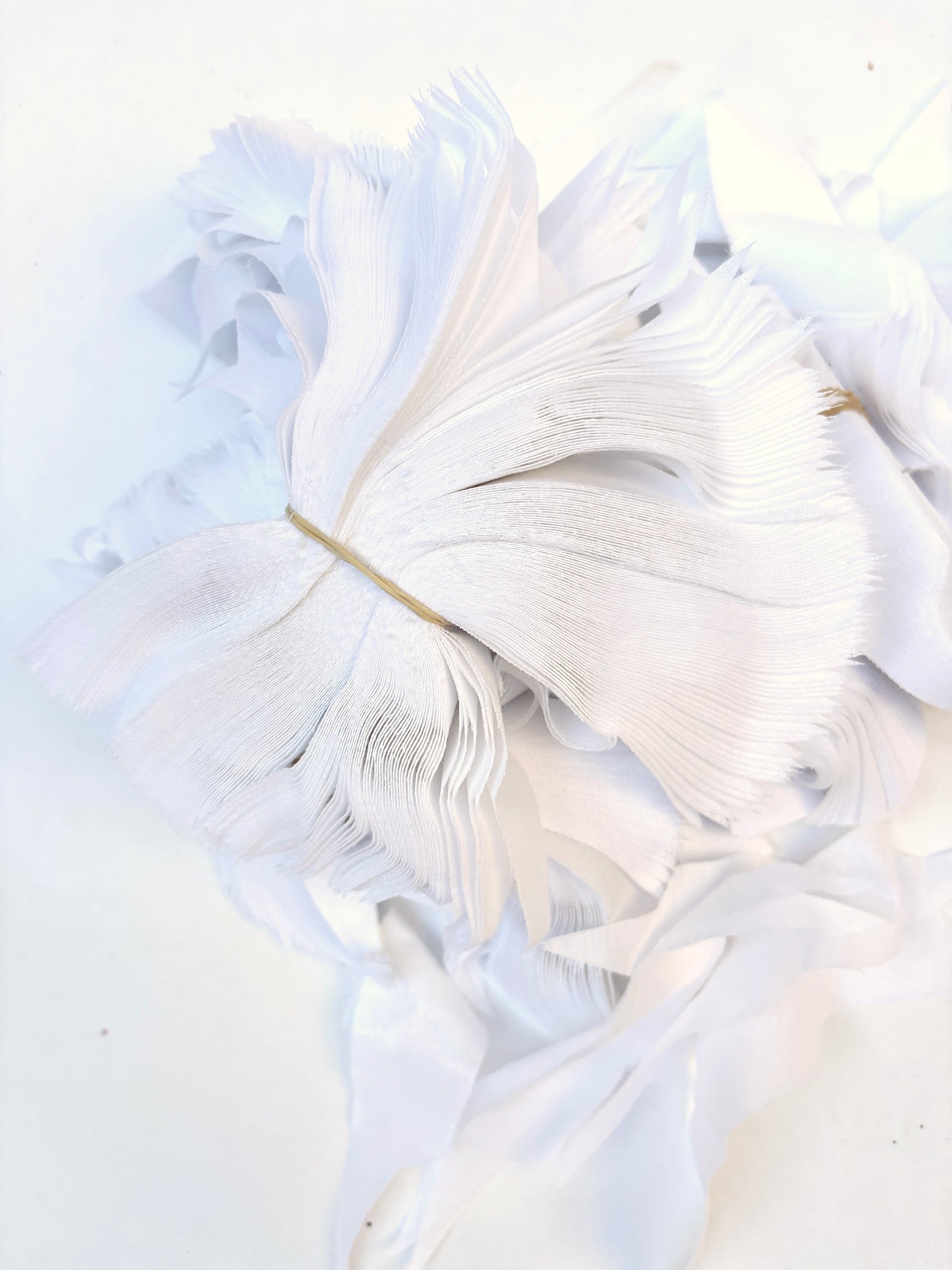 Bundles of fusible woven interfacing offcuts fabric in white 