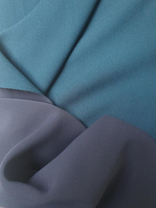 Close-up of heavy double-backed fabric in dark teal, soft texture visible 