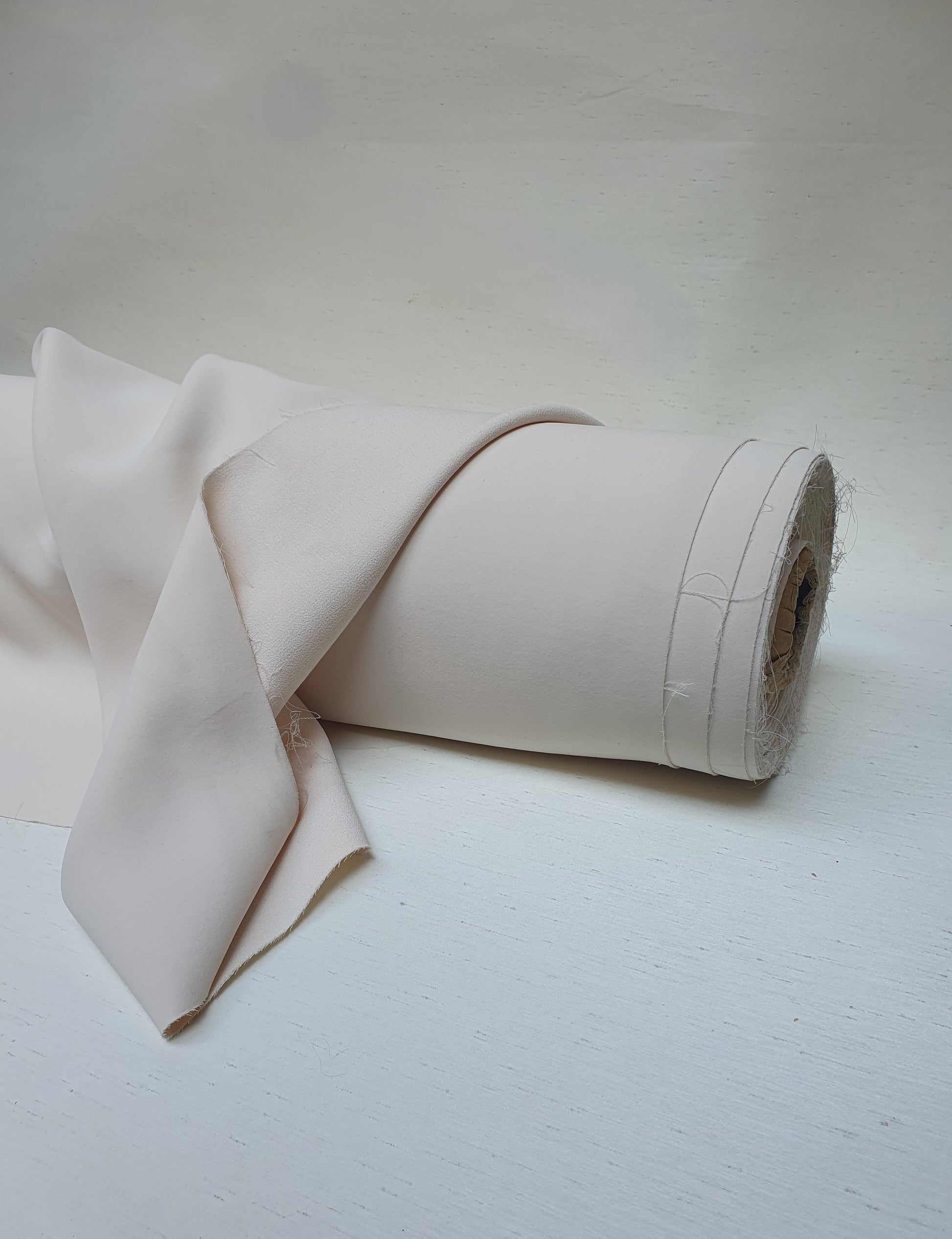 Roll of heavy double-backed fabric in cream white
