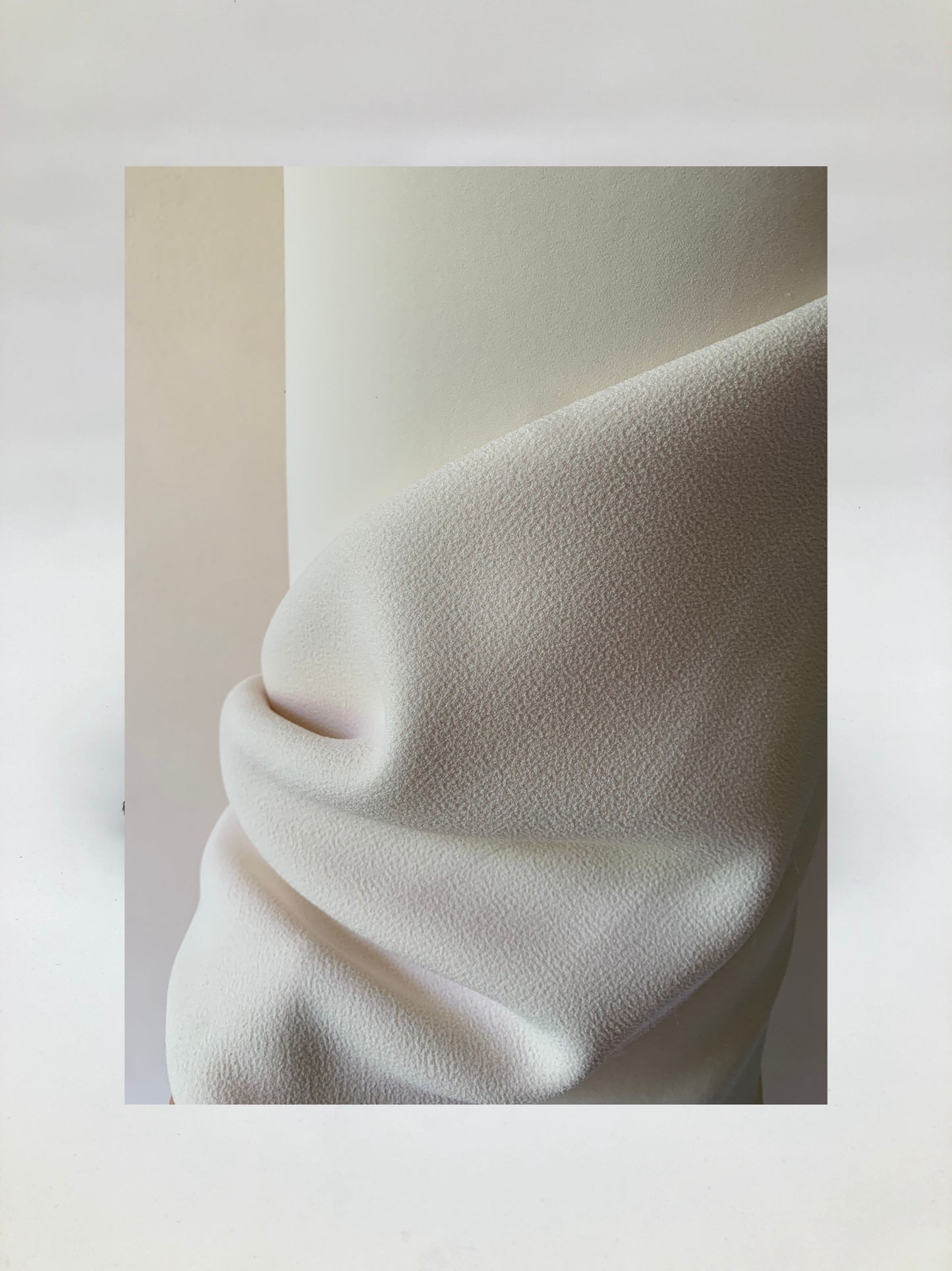 Close-up of heavy double-backed fabric in cream white, soft texture visible 