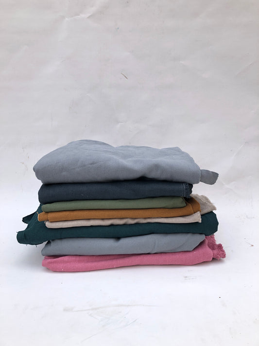 Stack of heavyweight linen fabric in various colours 