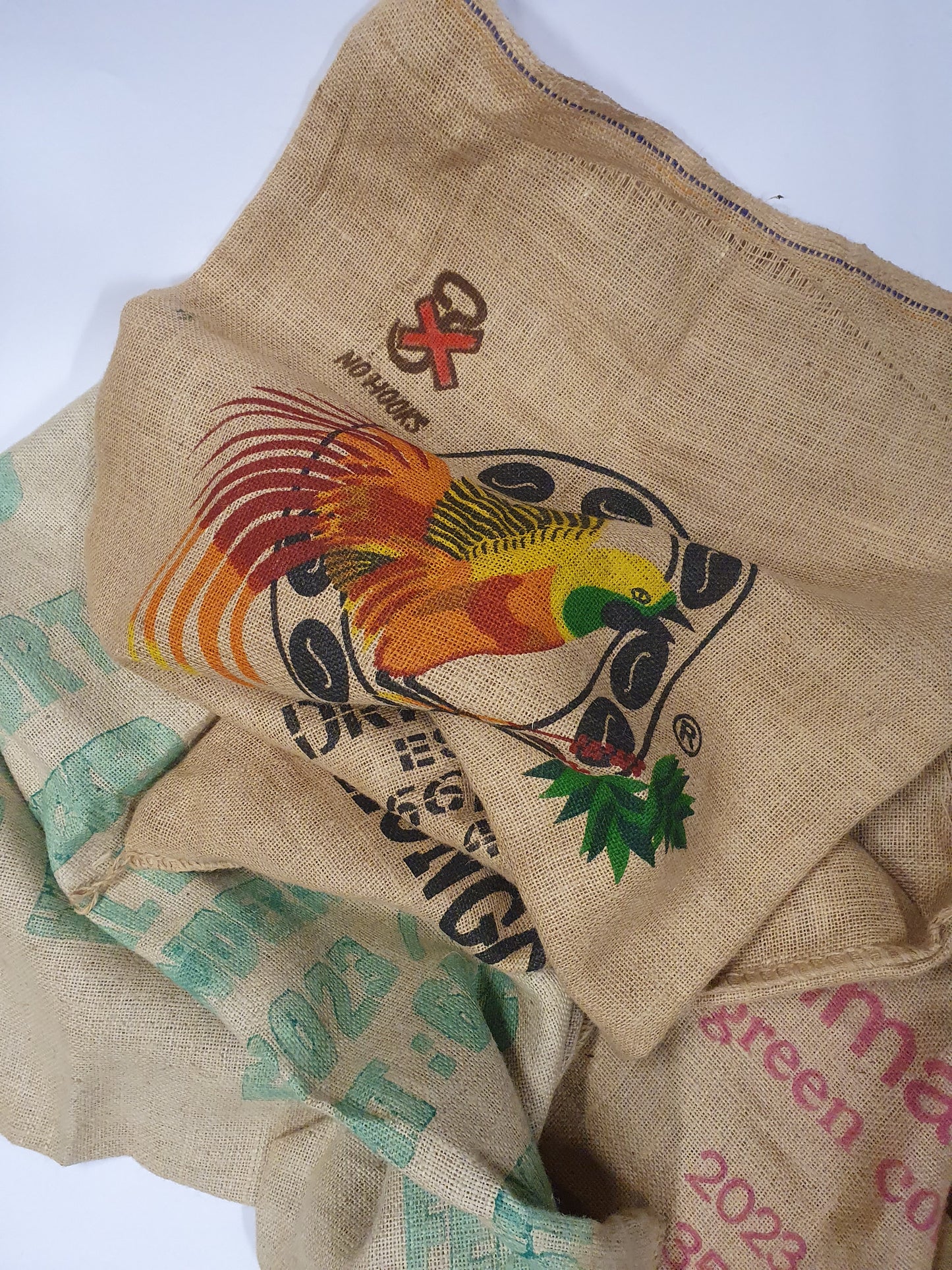 Stack of hessian fabric coffee jute sack with printed on designs and words