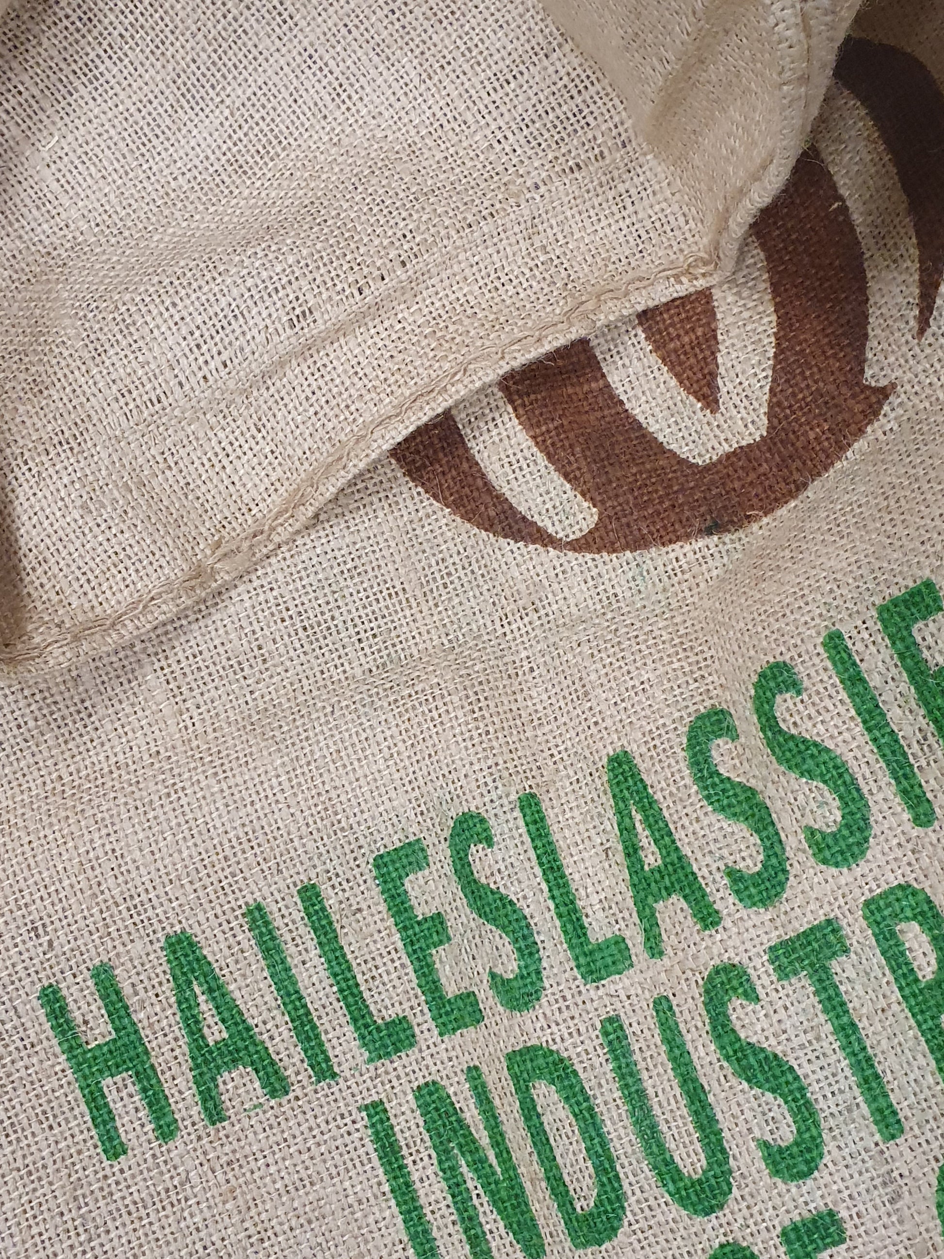 Close-up of hessian fabric coffee jute sack with words printed on