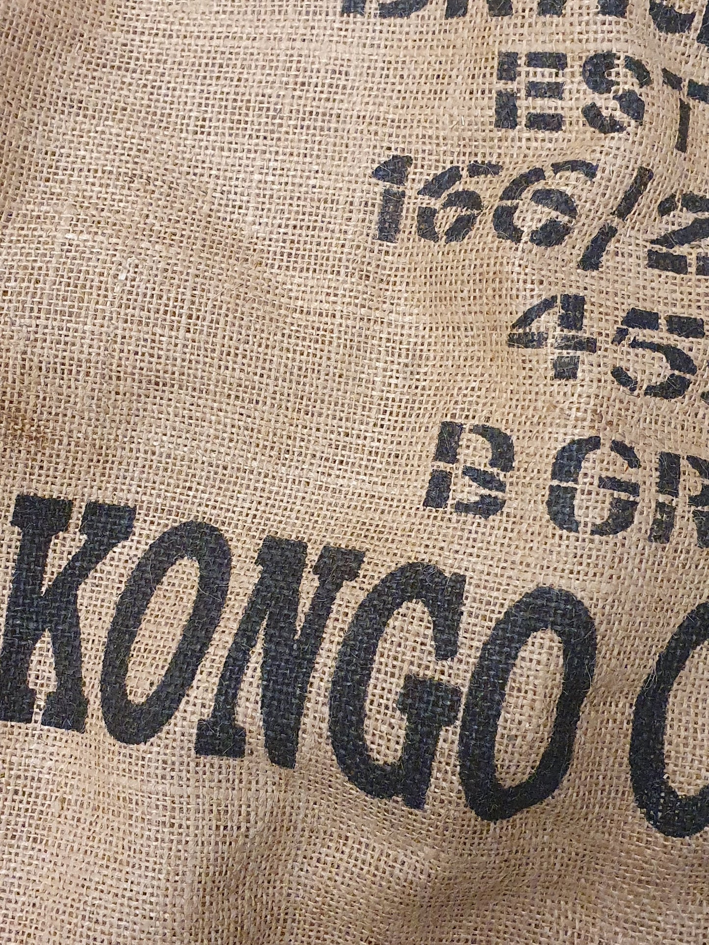 Close-up of hessian fabric coffee jute sack with text printed on