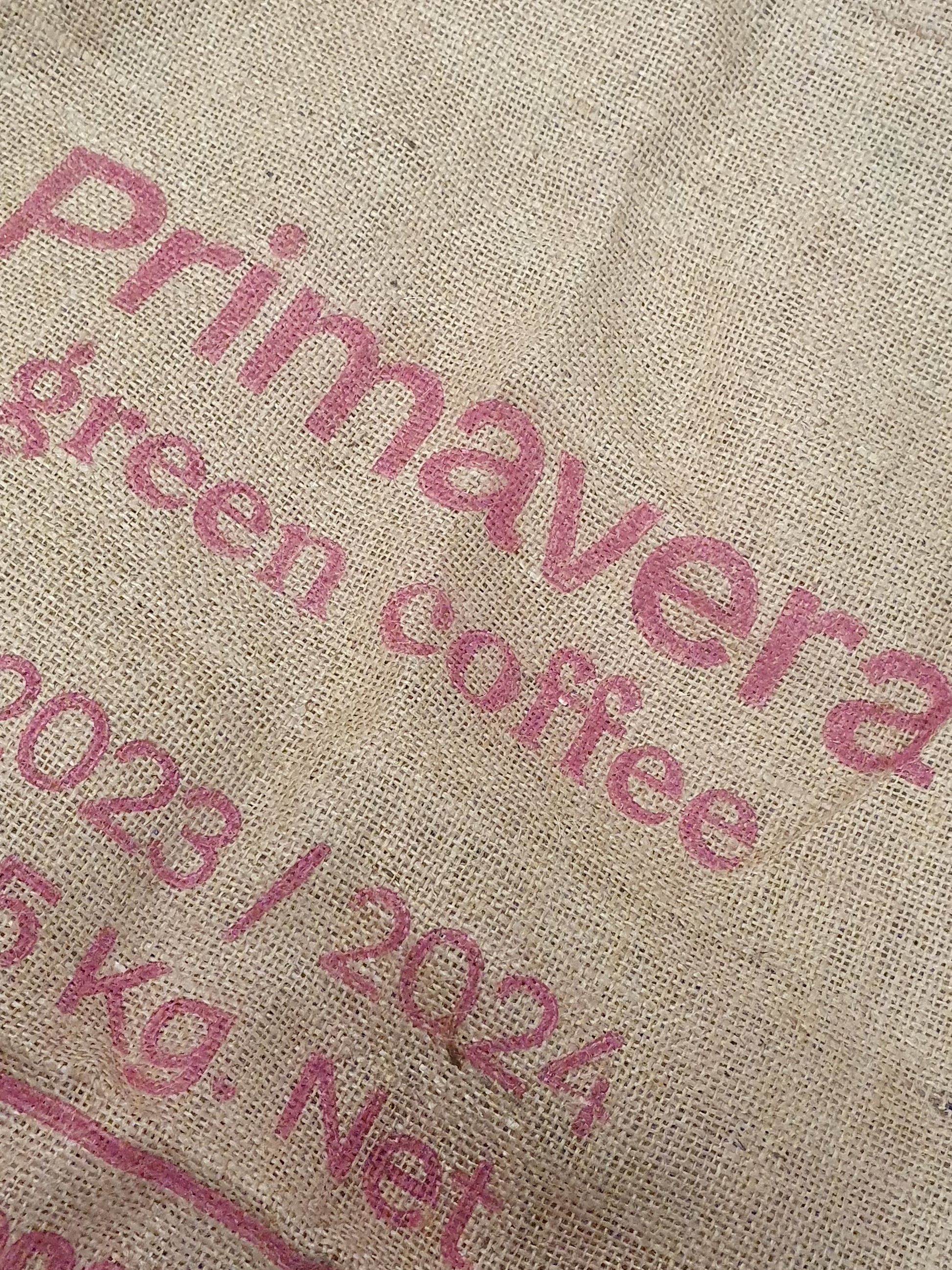 Close-up of hessian fabric coffee jute sack with text printed on
