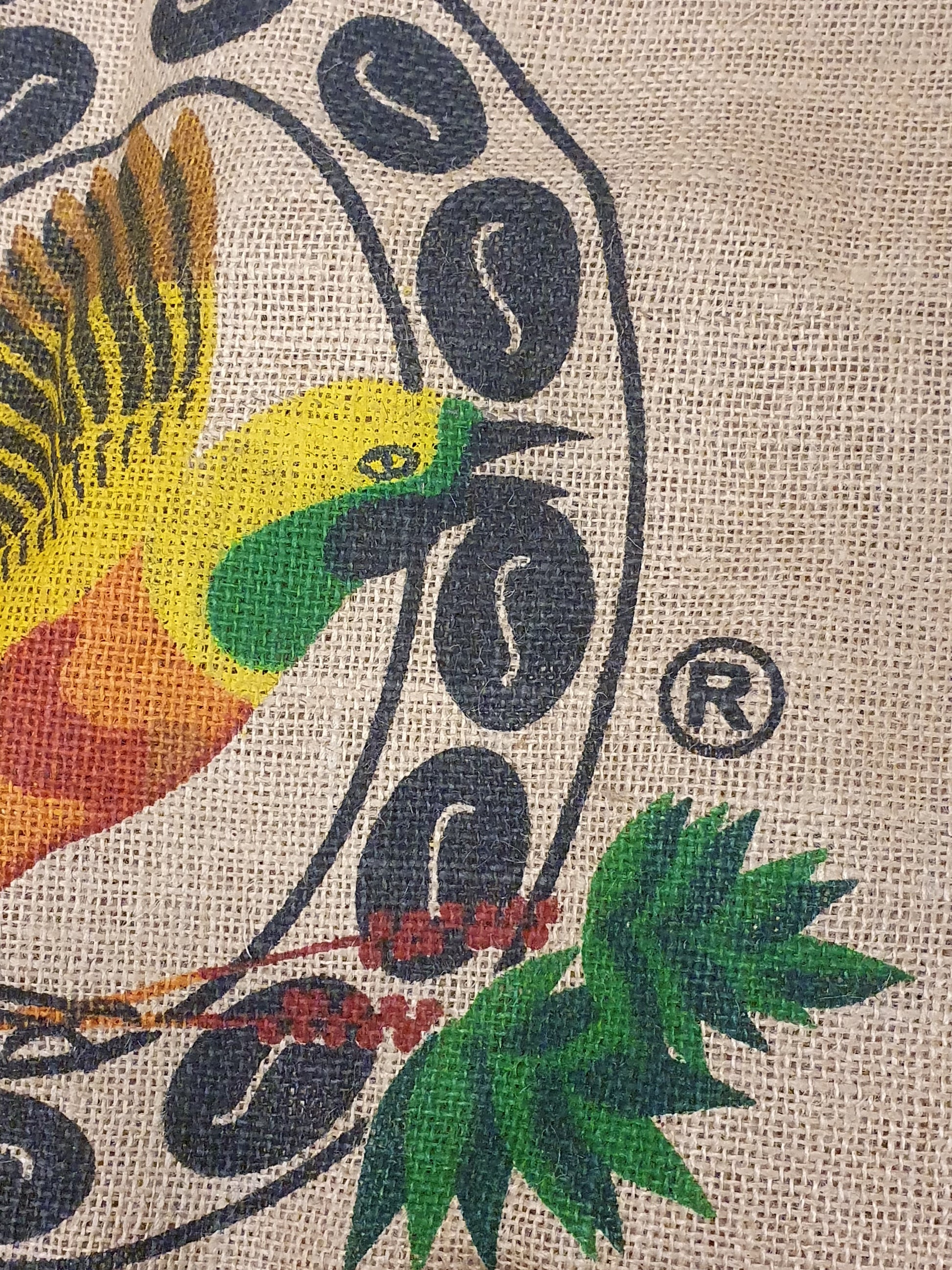 Close-up of hessian fabric coffee jute sack with bird printed on