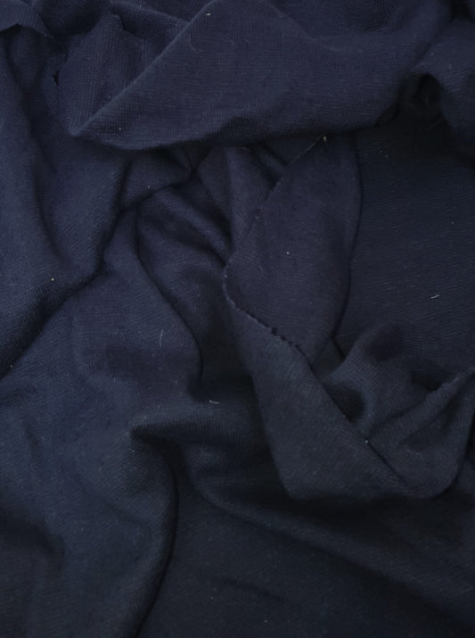 Close-up of light weighted jersey fabric in navy, soft texture visible 
