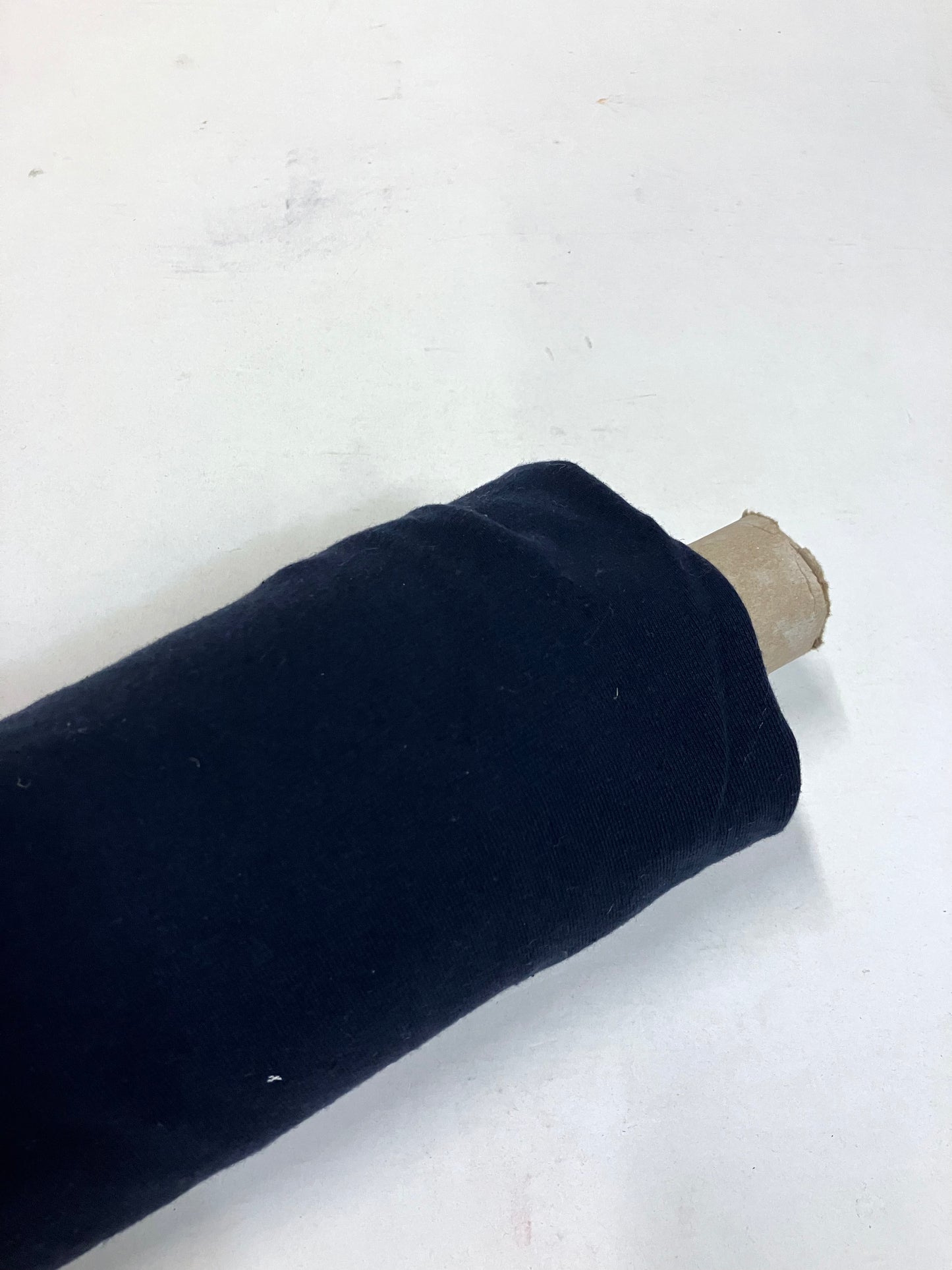 Roll of light weighted jersey fabric in navy