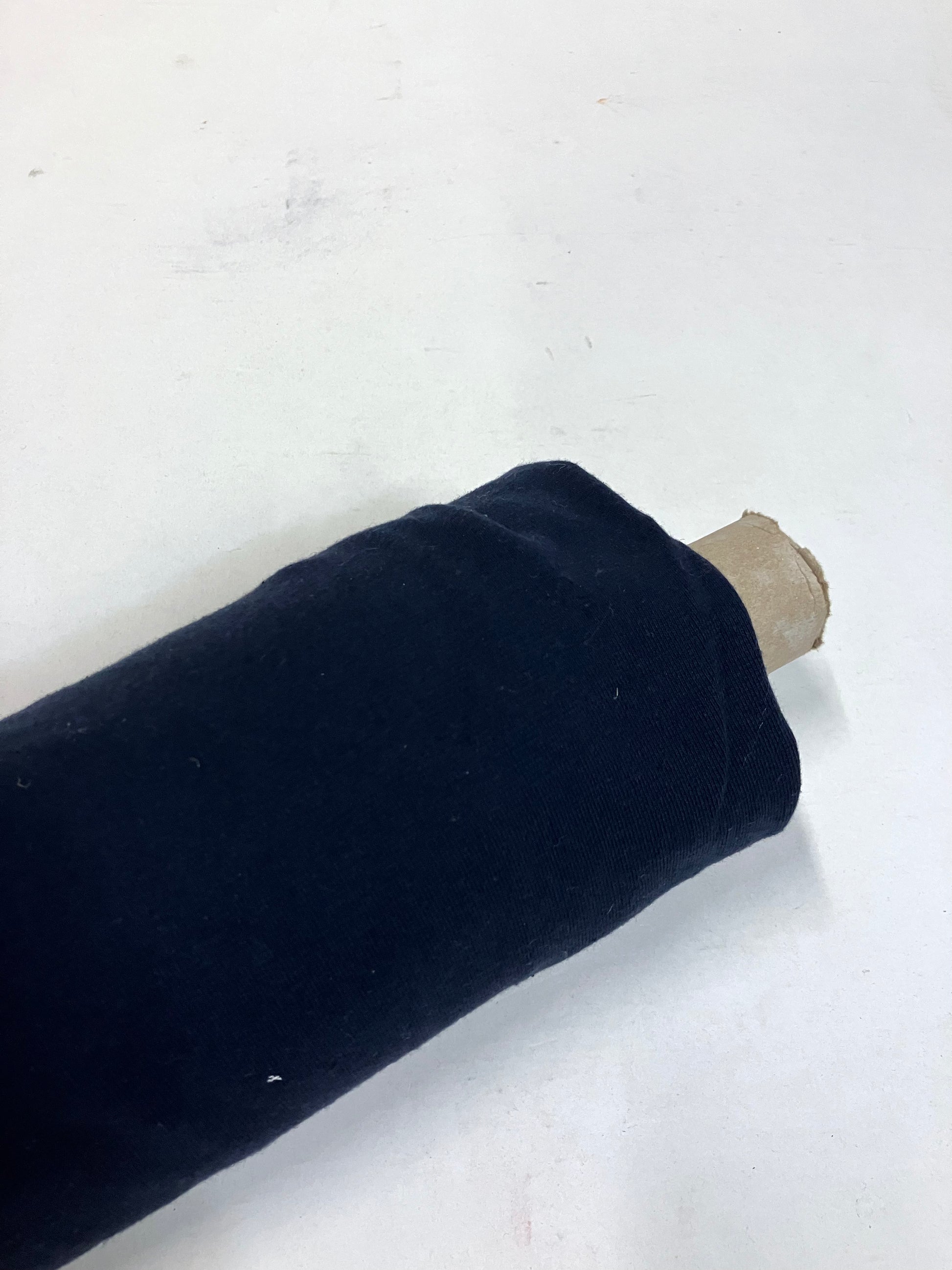 Roll of light weighted jersey fabric in navy