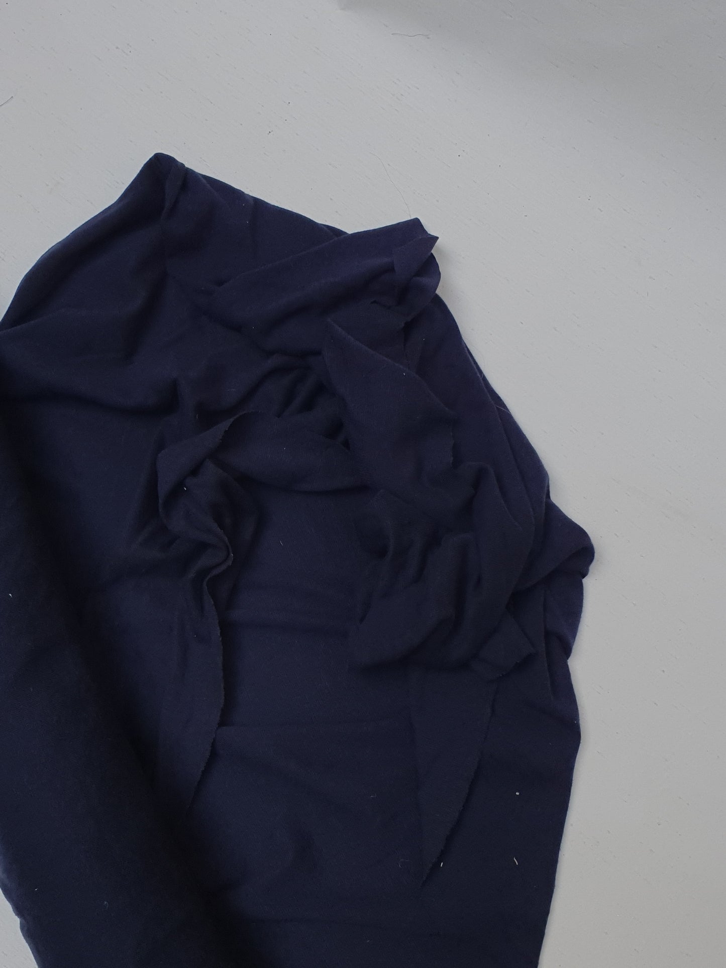 Light weighted jersey fabric in navy, soft texture visible 
