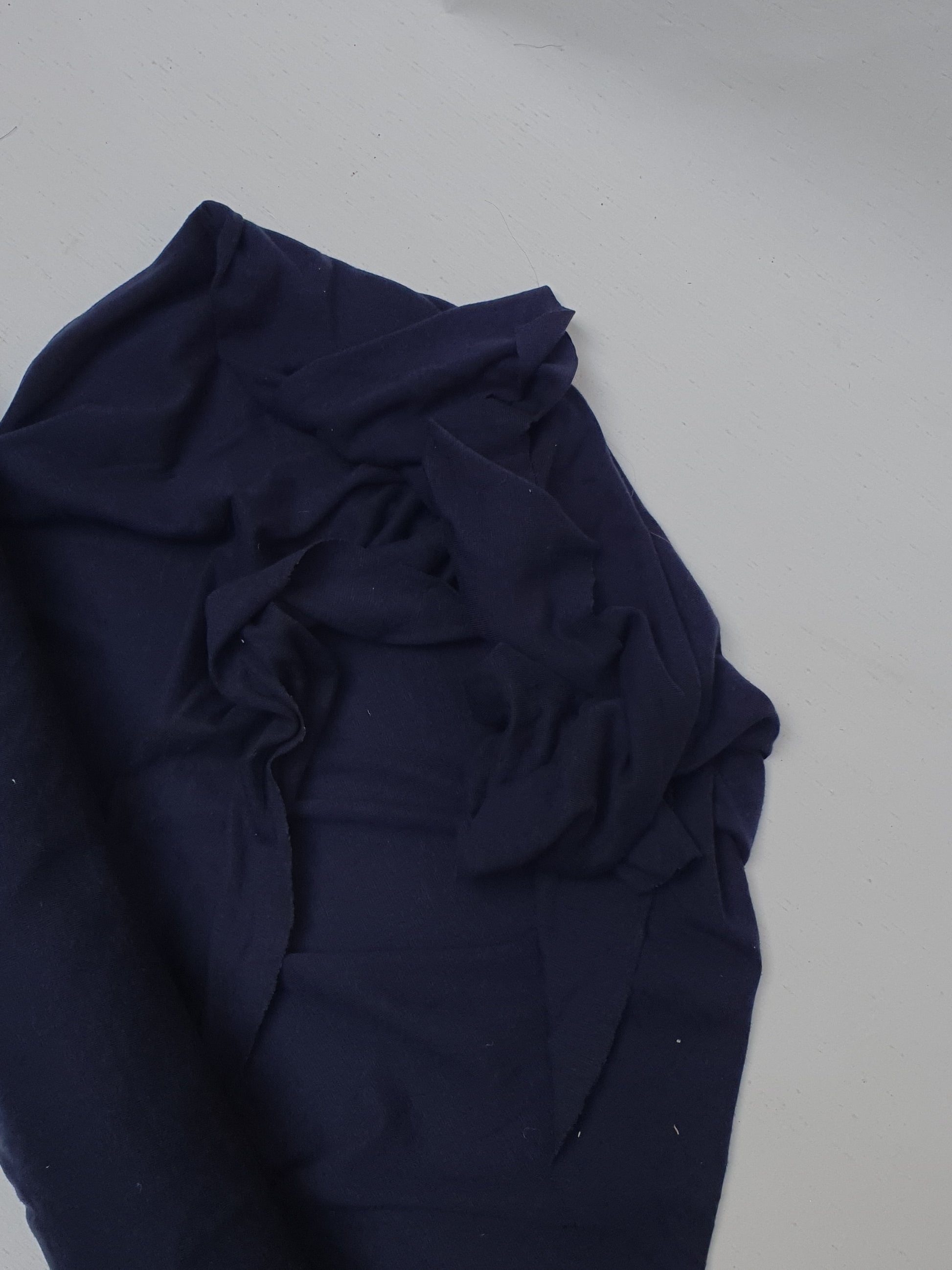 Light weighted jersey fabric in navy, soft texture visible 