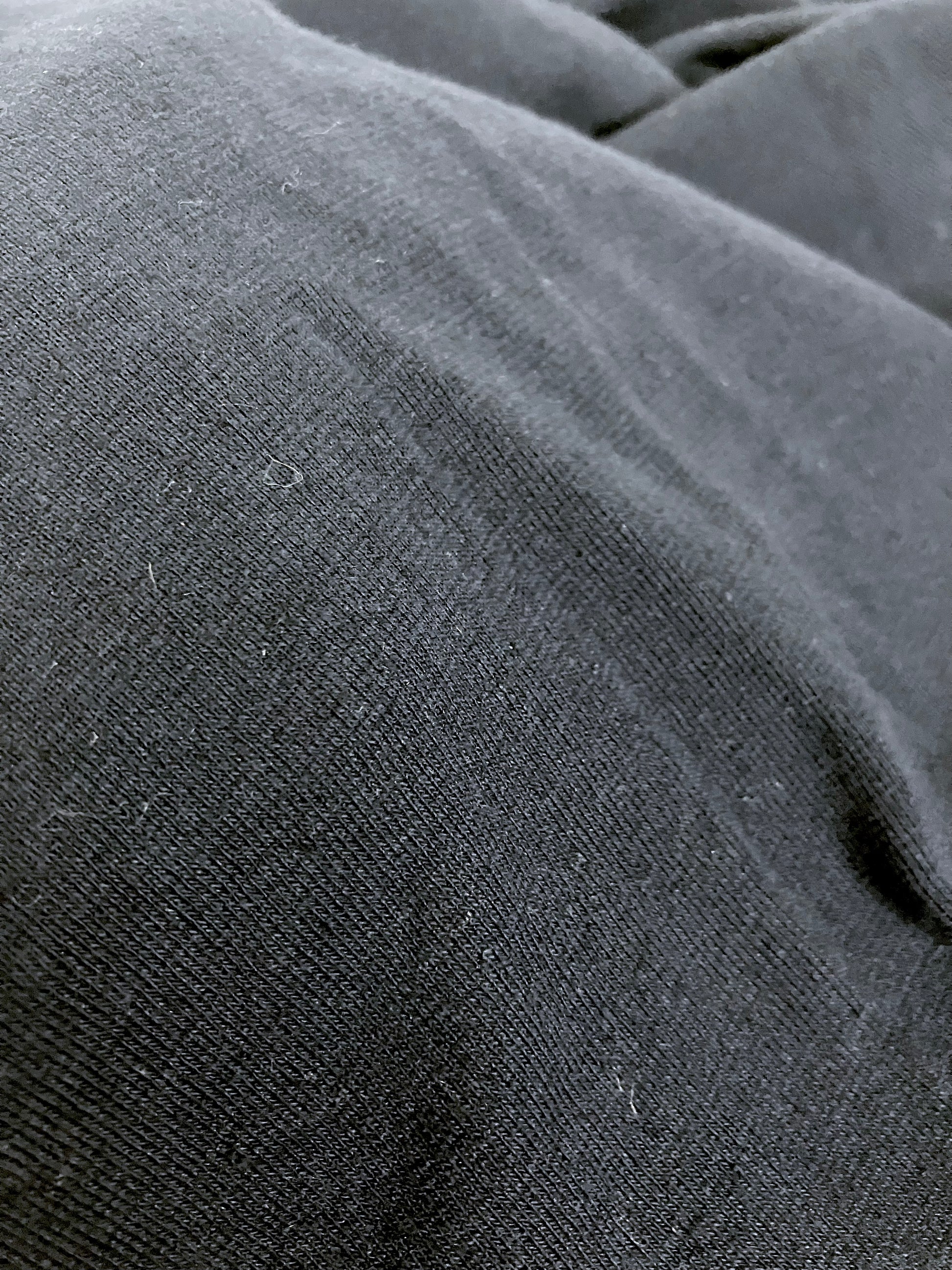 Close-up of light weighted jersey fabric in navy, soft texture visible 