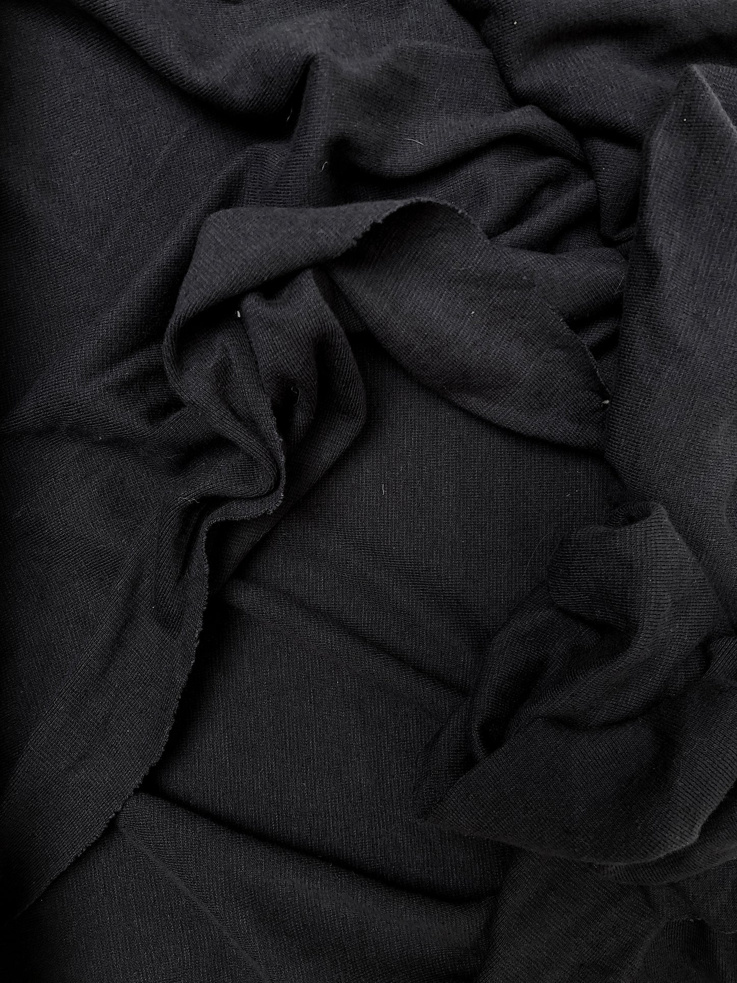 Close-up of wight weighted jersey fabric in black