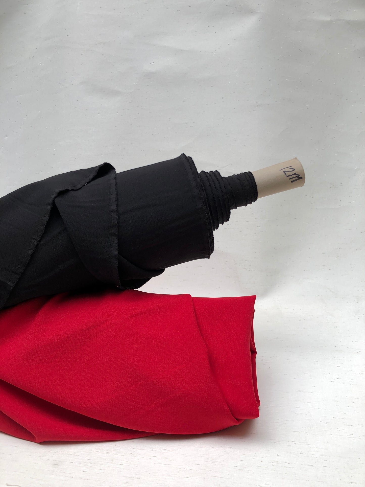 Two rolls of hopsack fabric in red and black