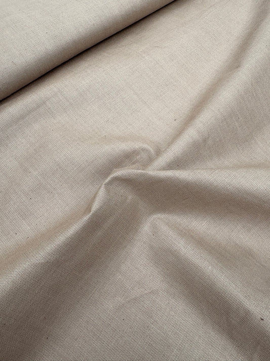 Close-up of waxy finishing natural fibre taffeta fabric in dark khaki, shiny texture visible 