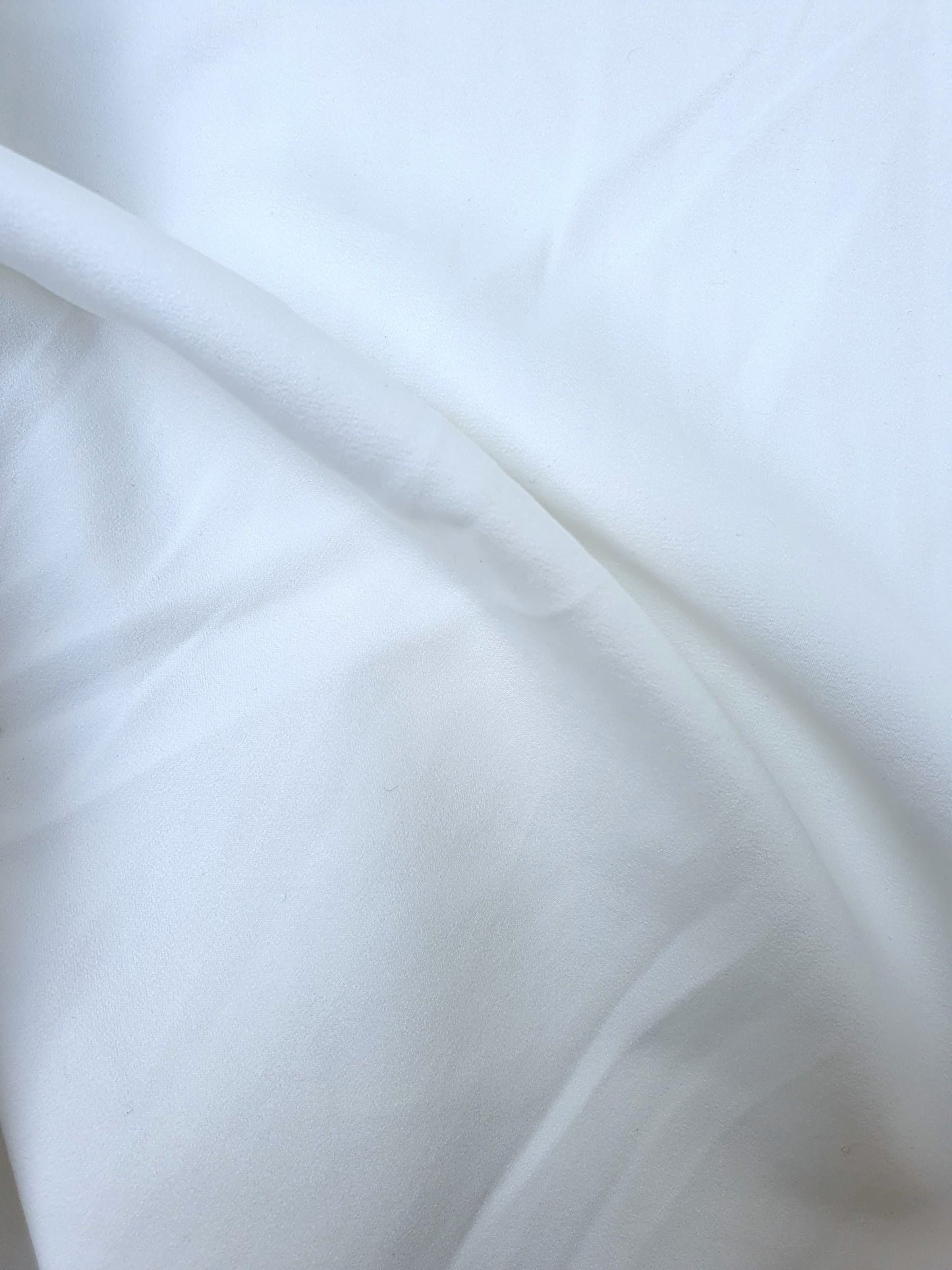 Close-up of polyester fabric in Nevada white, soft texture visible 