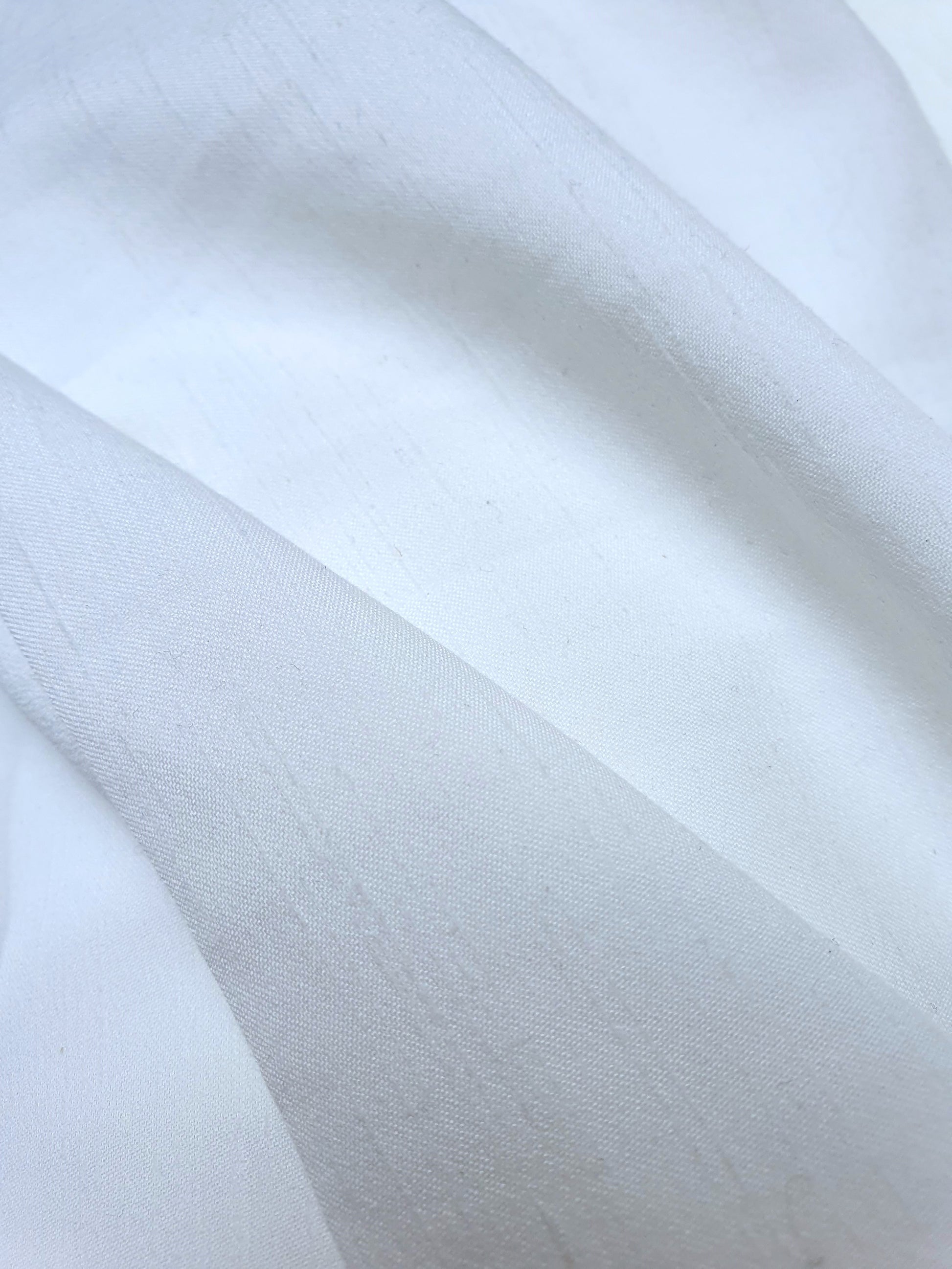 Close-up of polyester fabric in Nevada white, soft texture visible 