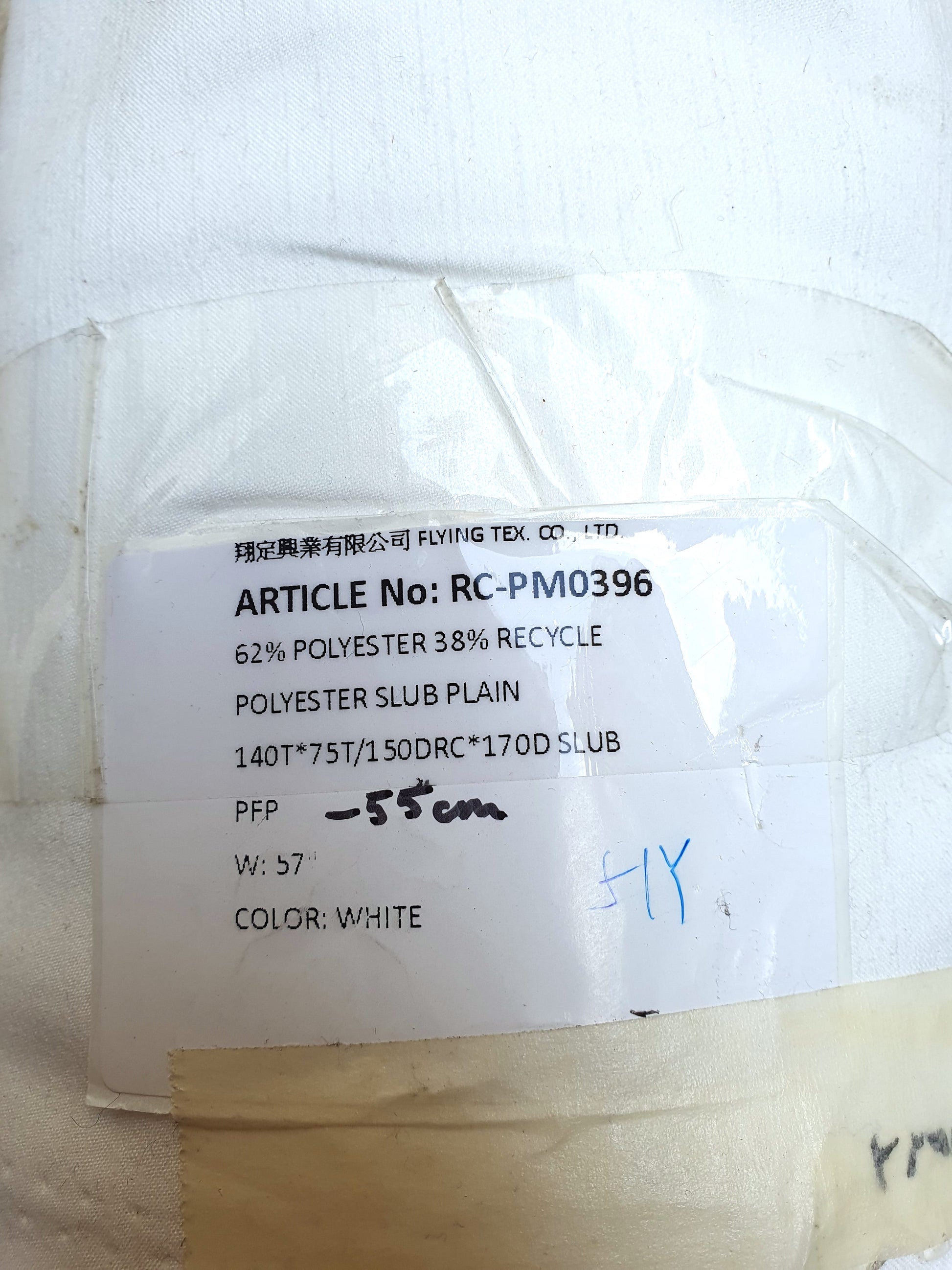 Polyester fabric in Nevada white with a sticker mentioning its details 