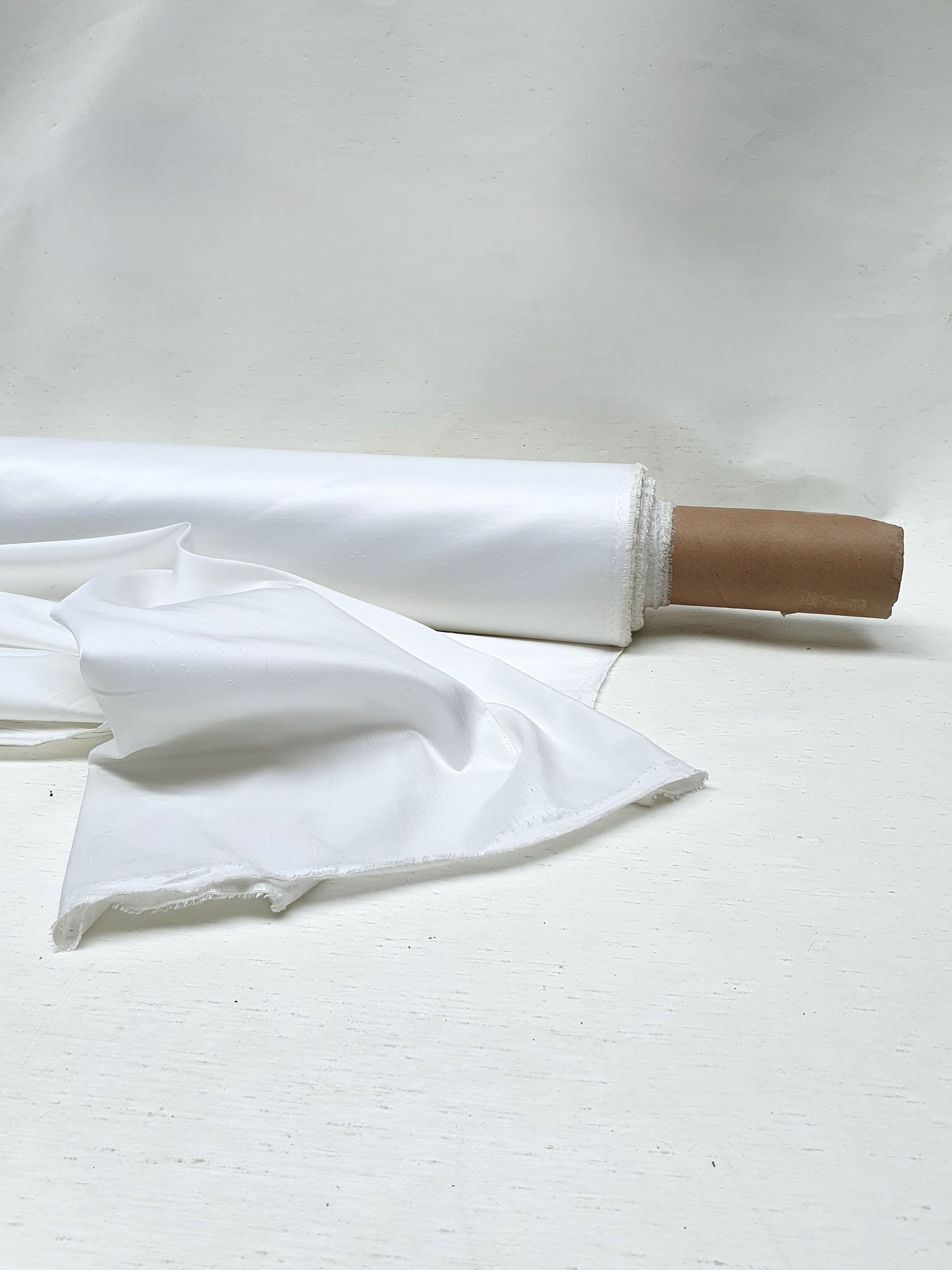 Roll of shiny polyester taffeta fabric in white