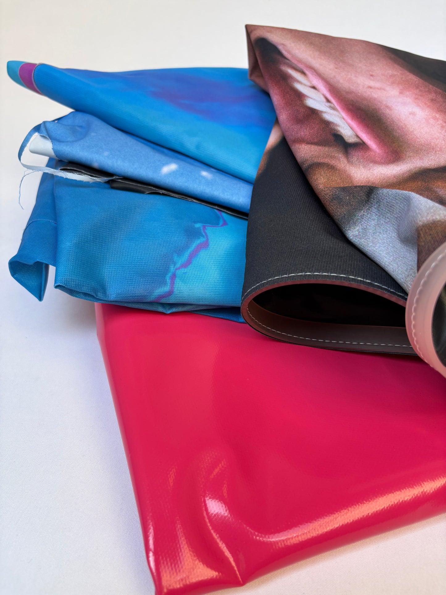 Close-up of folded fabric banners in various colours 