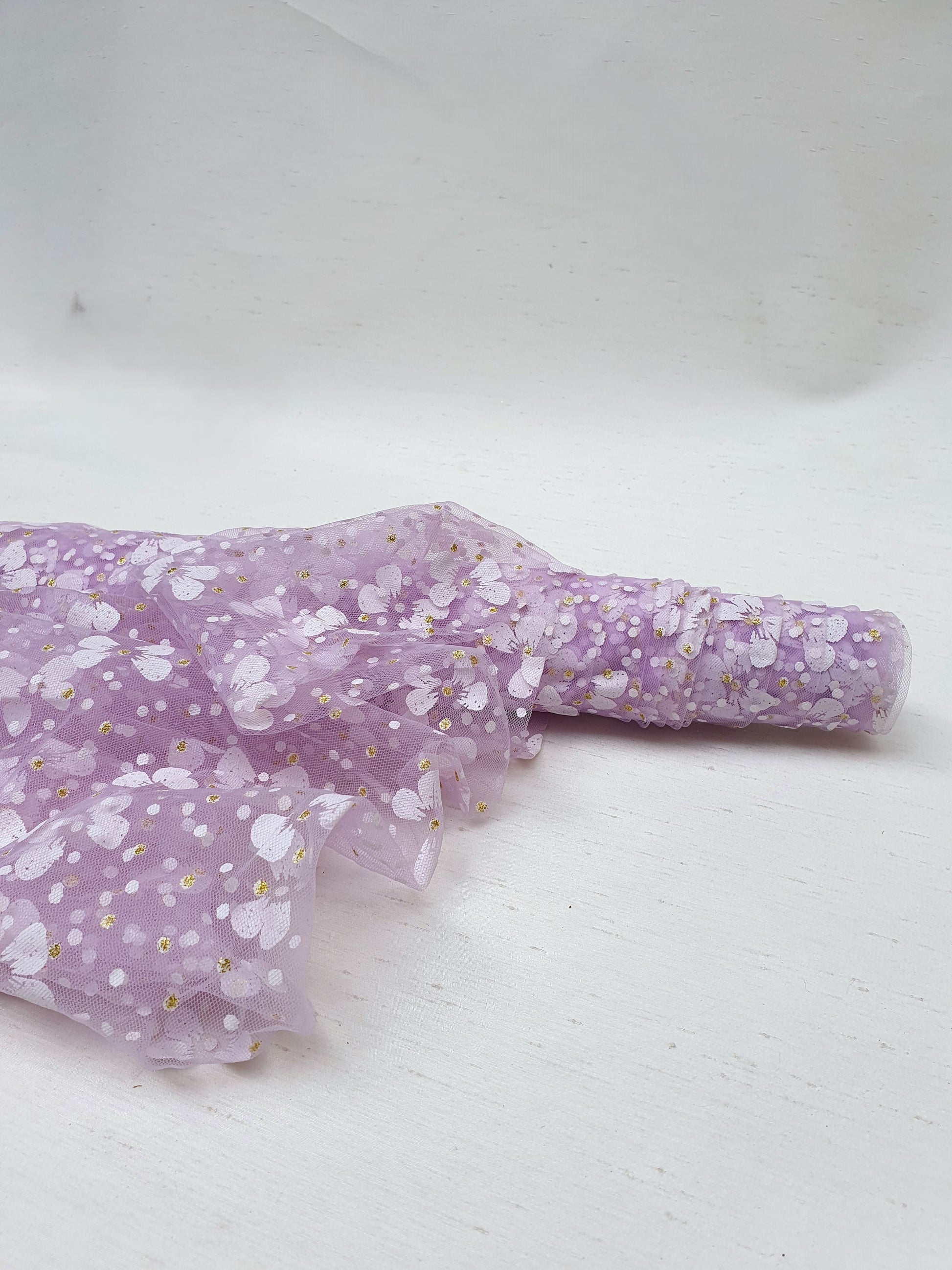 Roll of floral printed transparent mesh fabric in purple