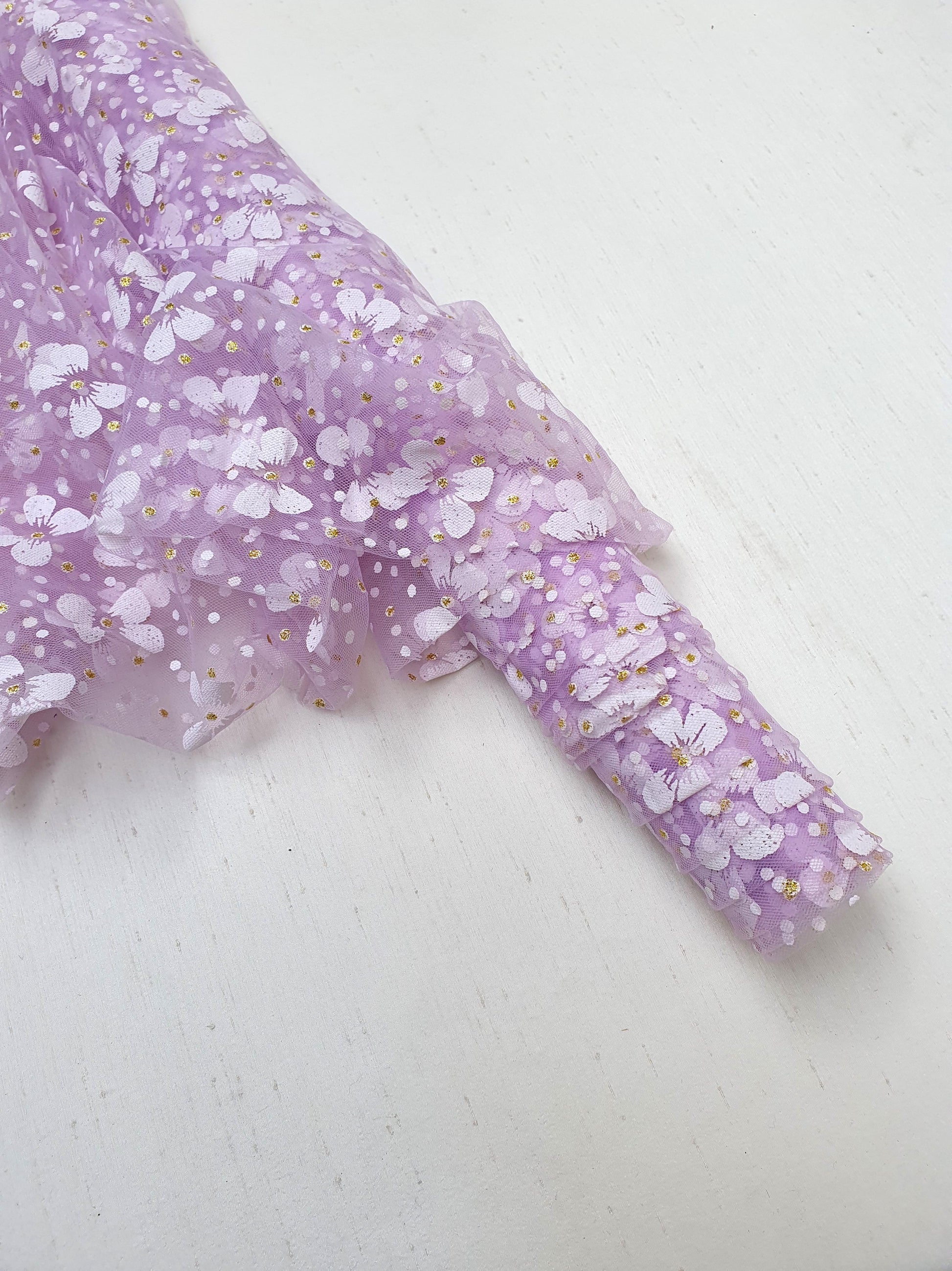 Roll of floral printed transparent mesh fabric in purple 