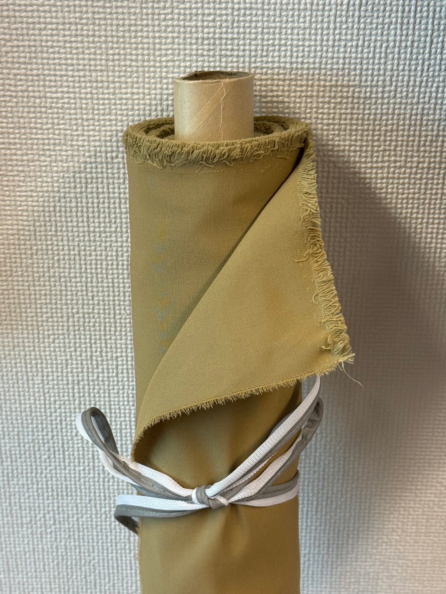 Roll of organic cotton blended with recycled nylon fabric in beige