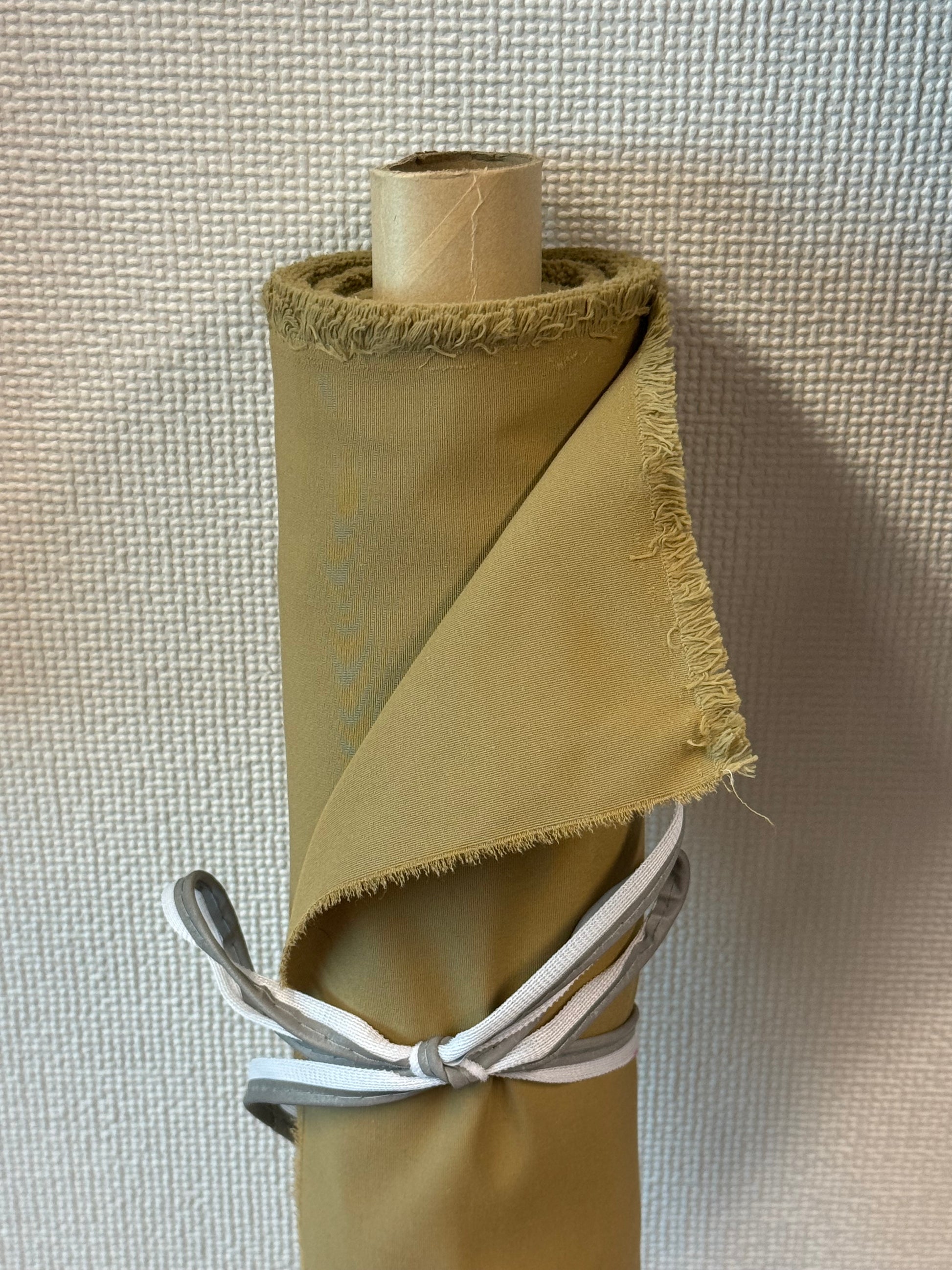 Roll of organic cotton blended with recycled nylon fabric in beige