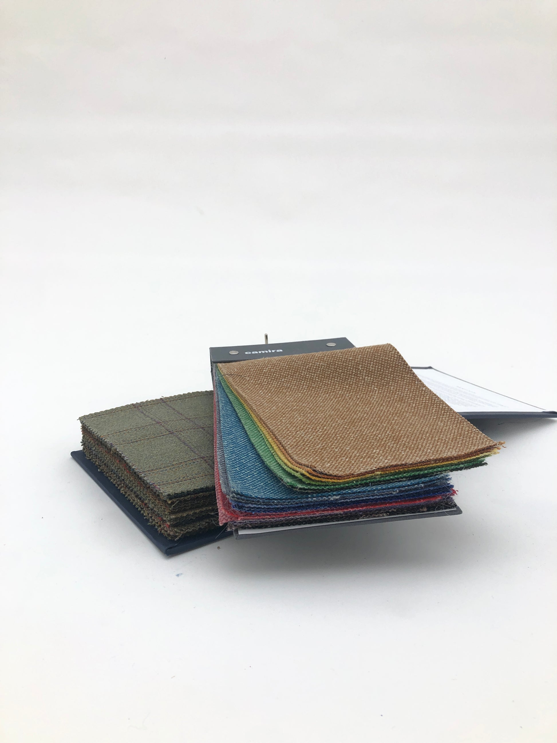 Collection of fabric sample books in various colours 