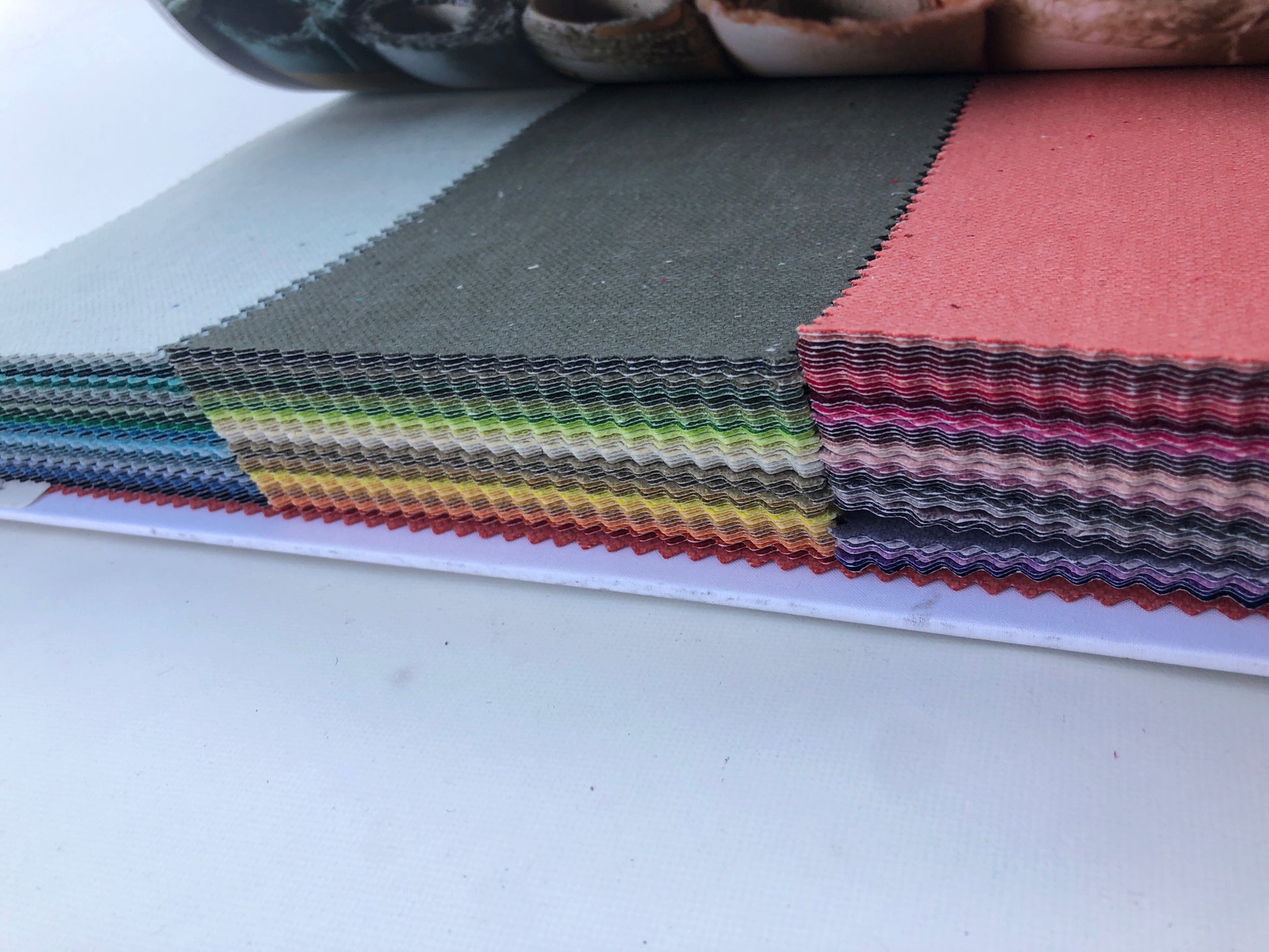 Collection of fabric sample books in various colours 