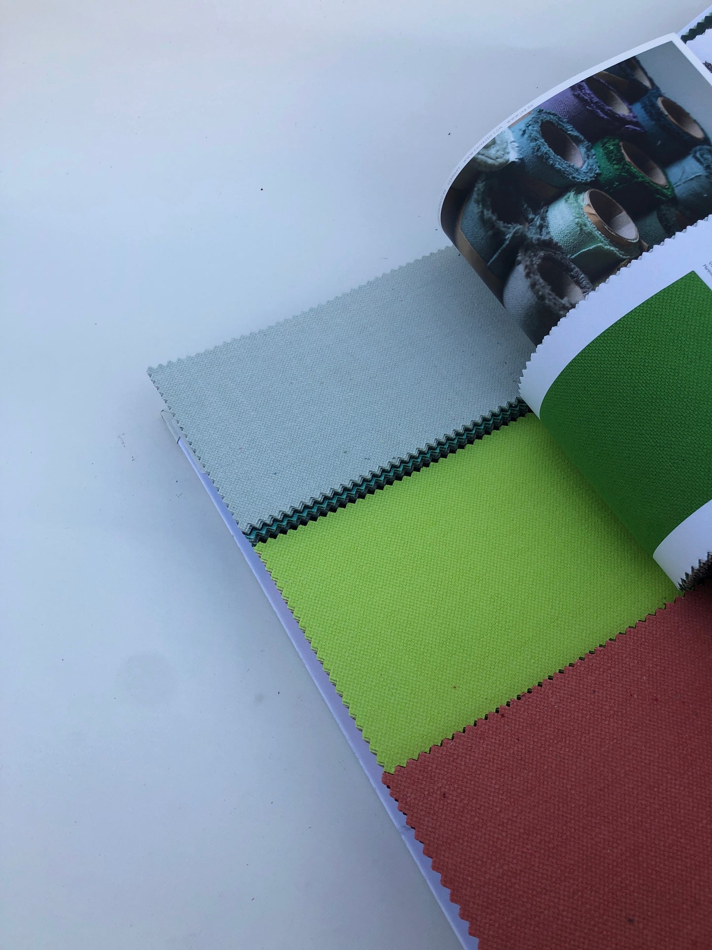 Collection of fabric sample books in various colours 