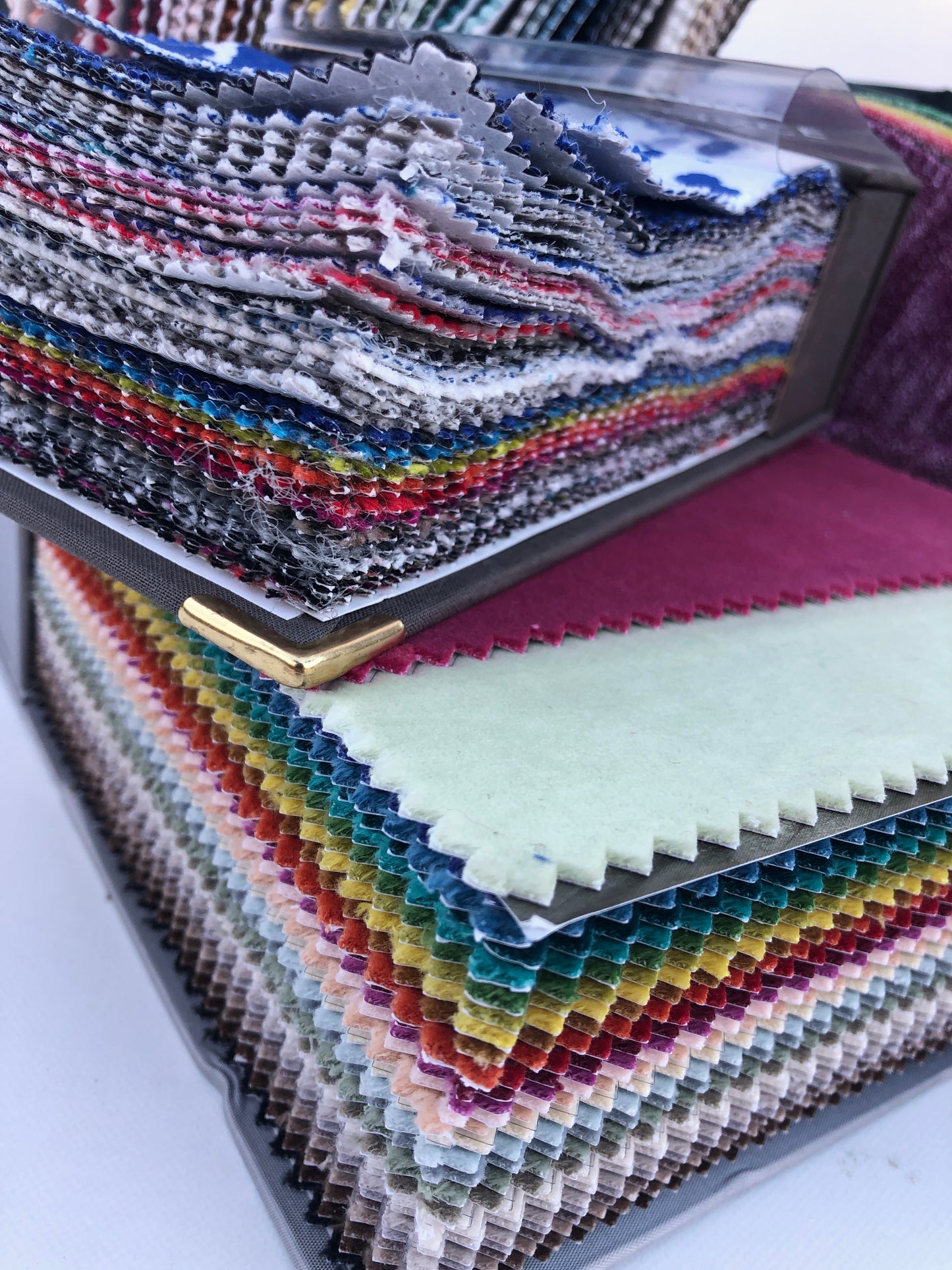 Collection of fabric sample books in various colours 