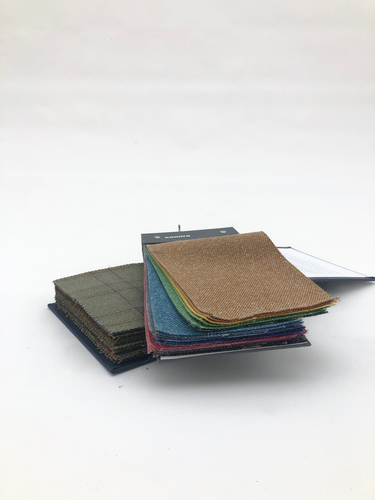 Collection of fabric sample books in various colours 