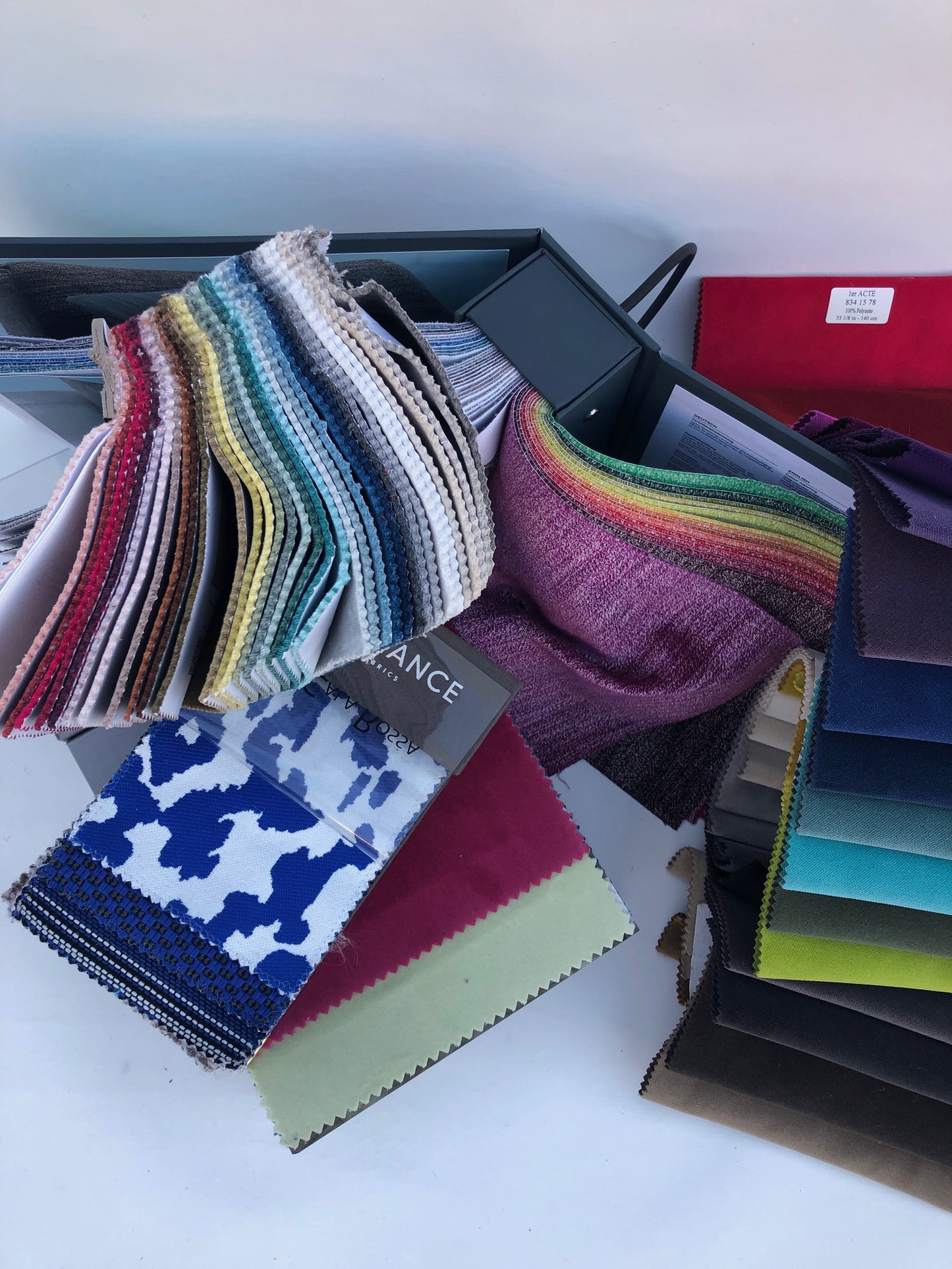Collection of fabric sample books in various colours 