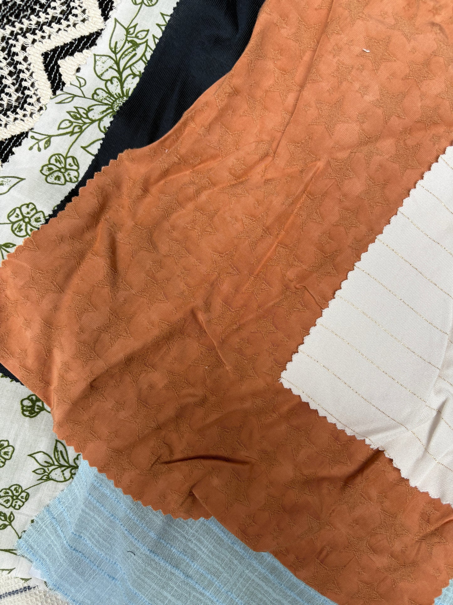 Collection of patterned fabric samples in various colours and textures 