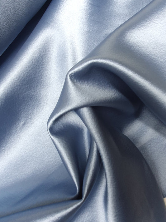Close-up of satin crepe double cloth fabric in baby blue