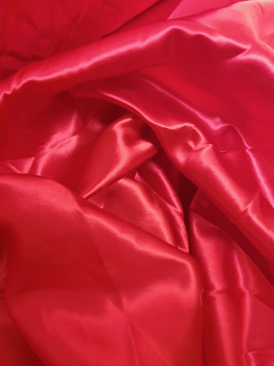 Close-up of satin fabric in passion red 