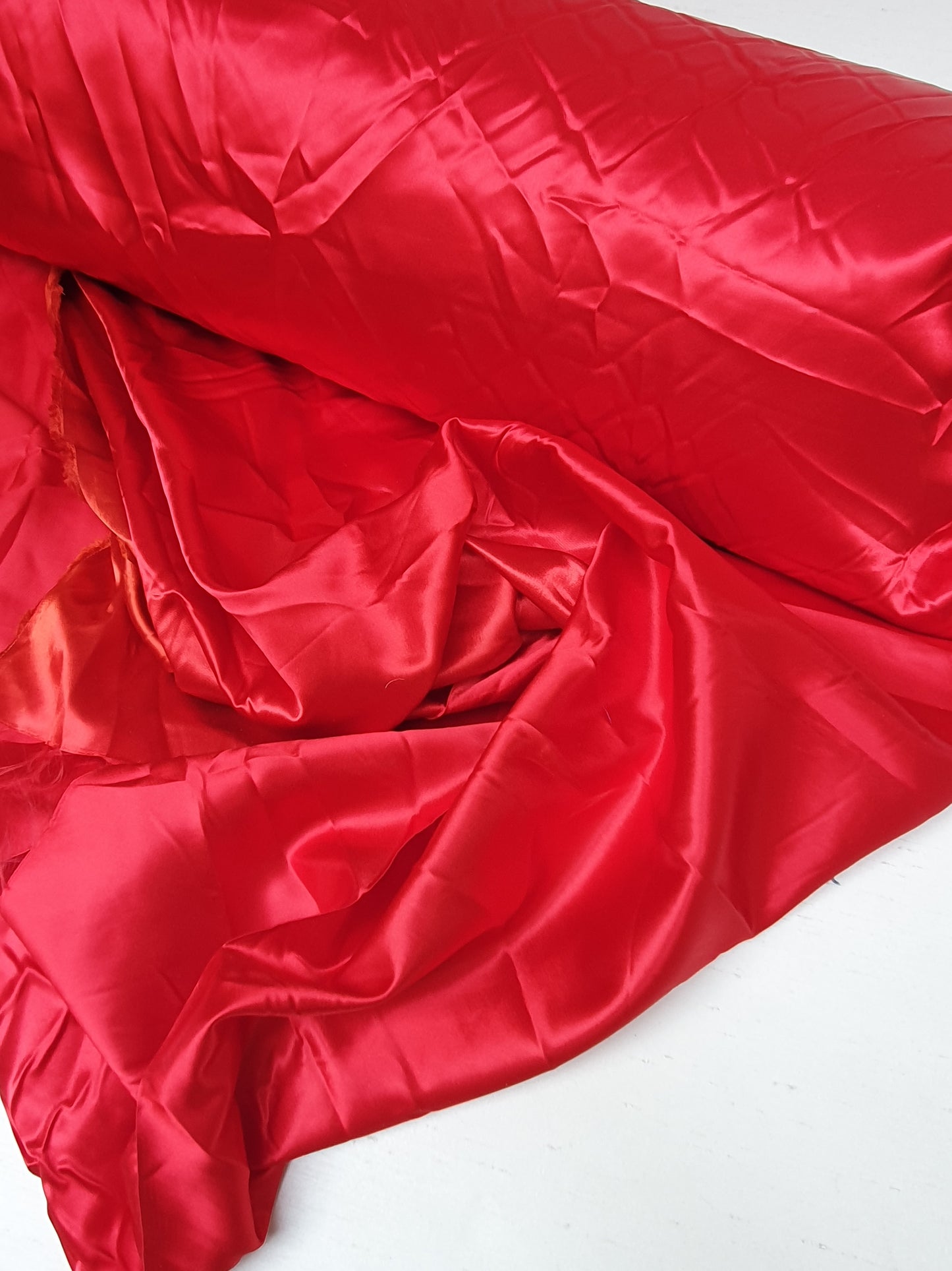 Close-up of satin fabric in passion red 