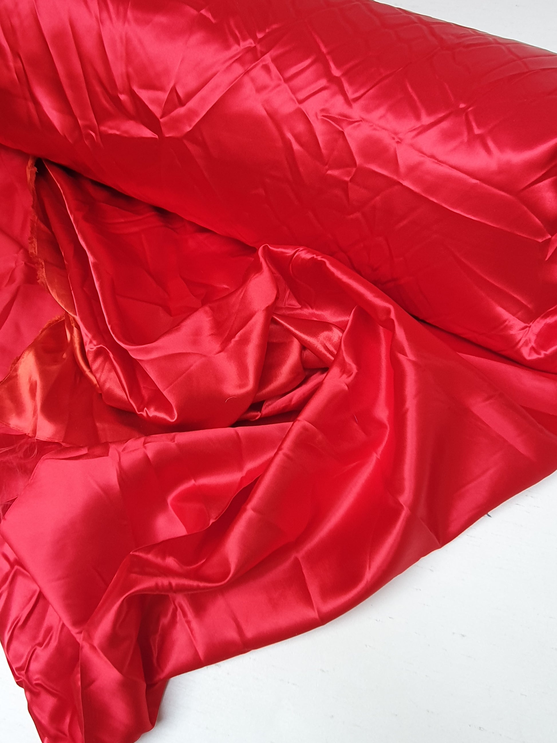 Close-up of satin fabric in passion red 