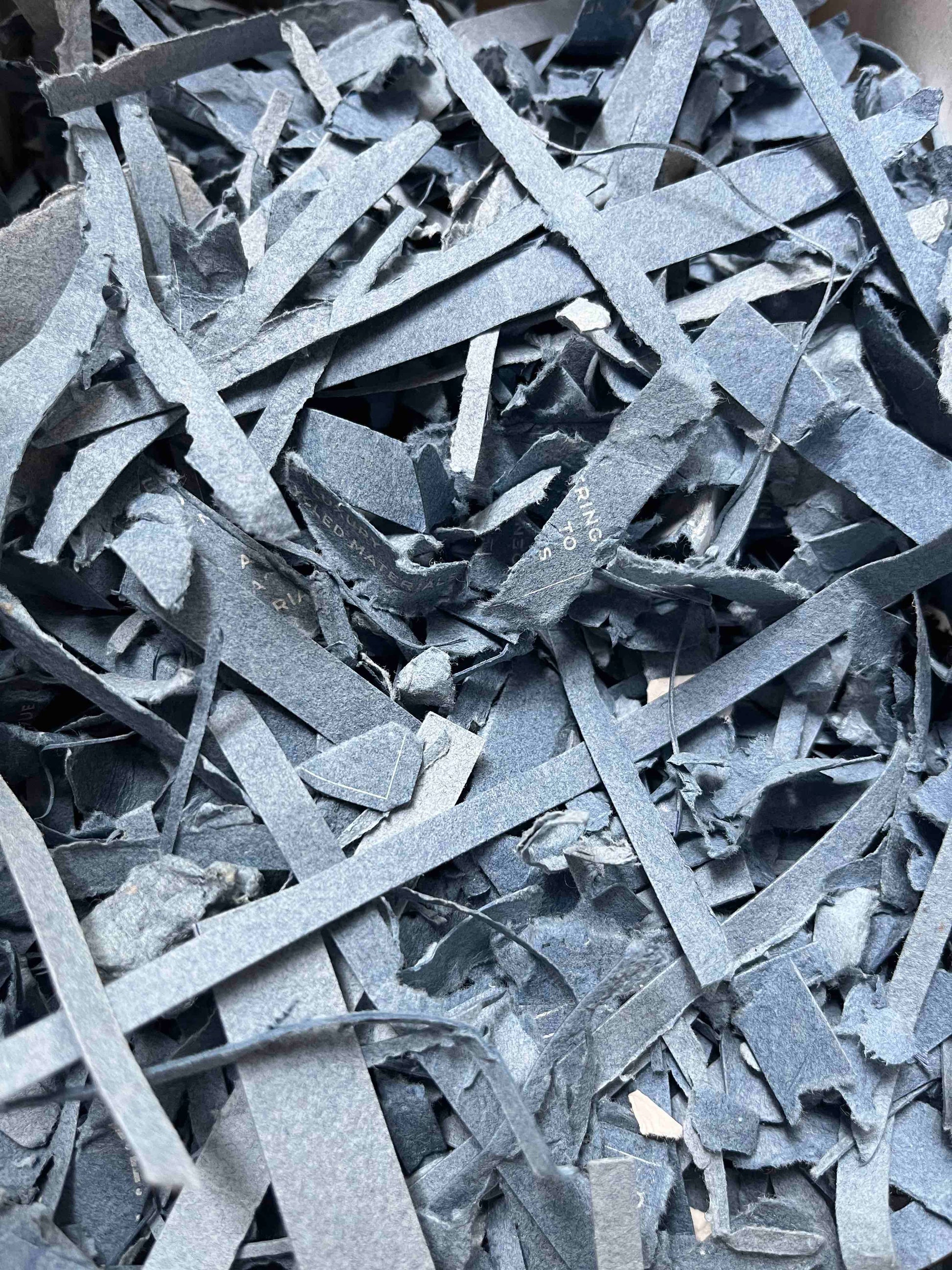 Close-up of shredded papertex offcuts in denim colour 