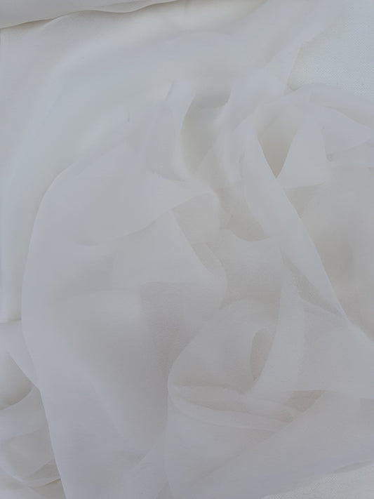 A close-up of translucent white silk organza fabric