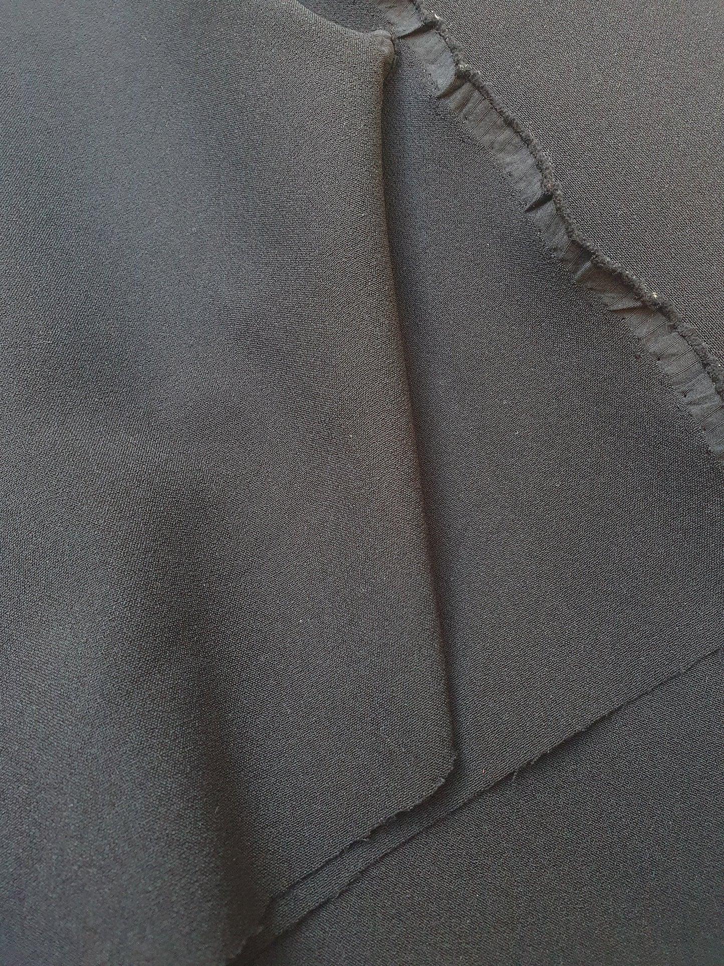 Close-up of stretch crepe fabric in black  with soft texture 