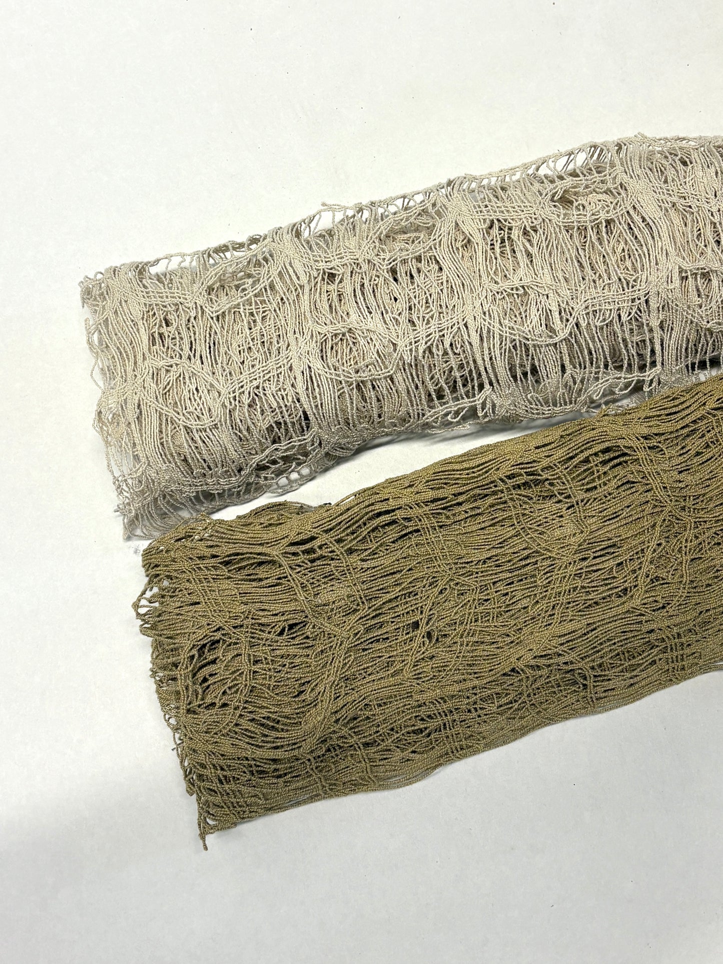 Two rolls of jute sheer fabric in beige and brown 