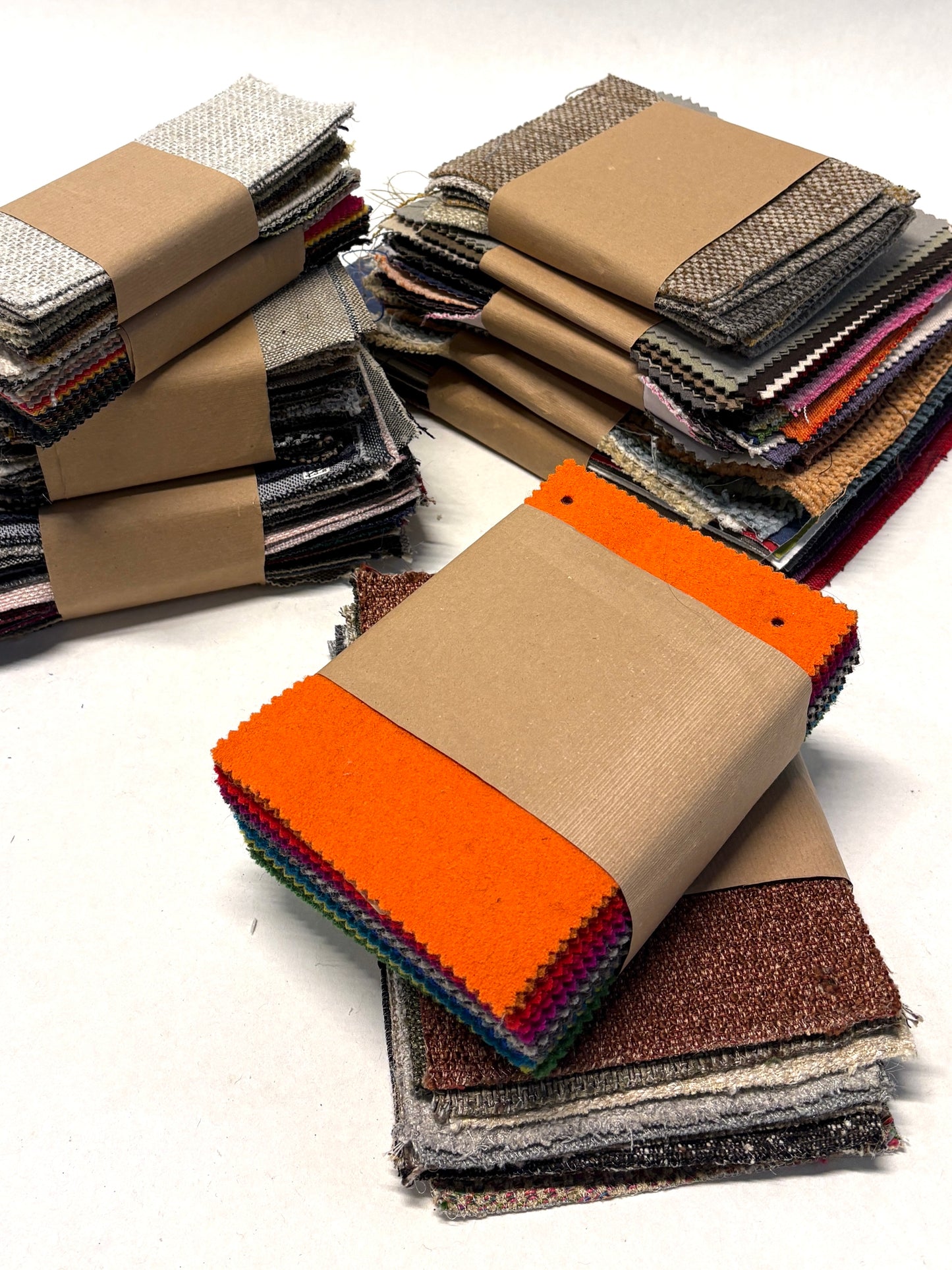 Stack of fabric swatches in various colours and textures 
