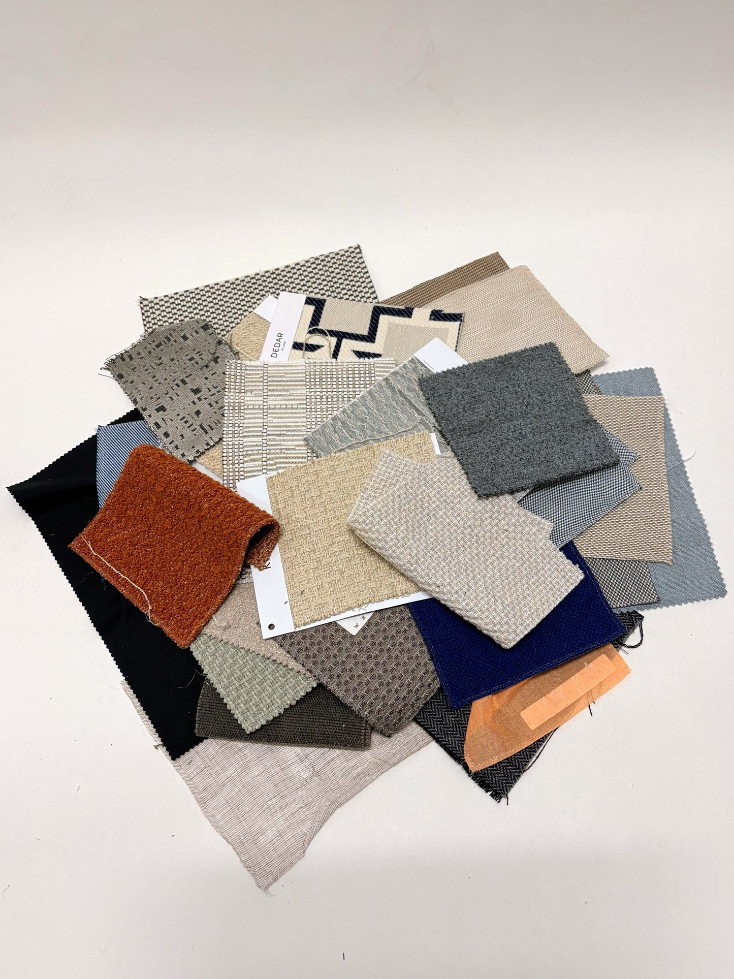 Collection of fabric swatches with various patterns and colours