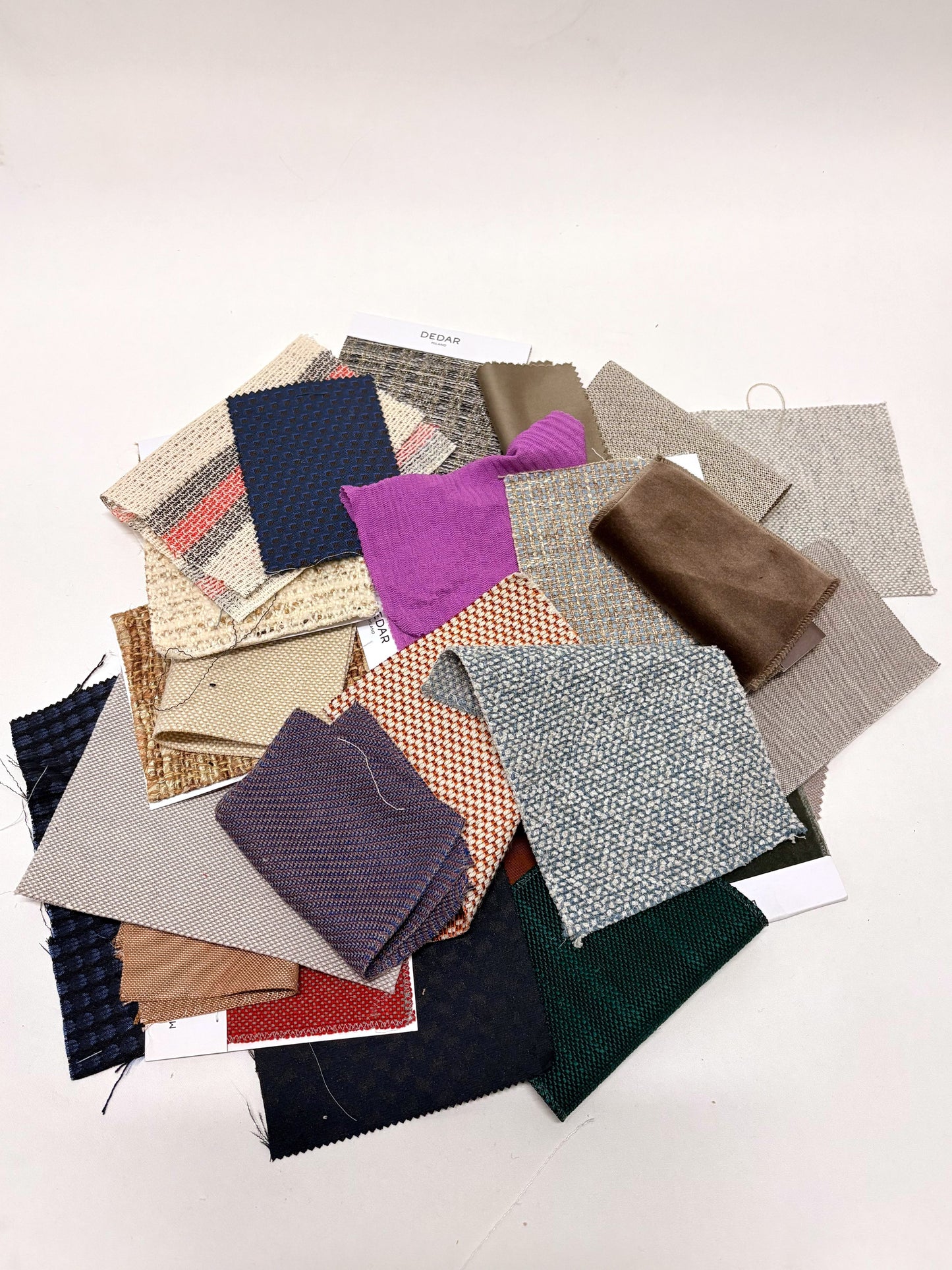 Collection of fabric swatches with various patterns and colours