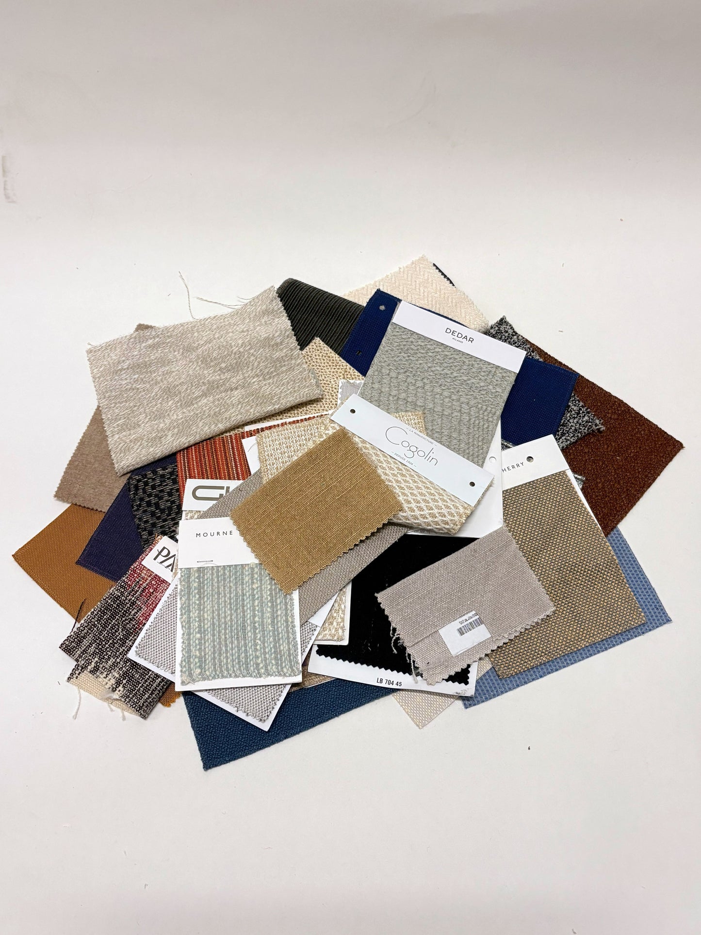 Collection of fabric swatches with various patterns and colours